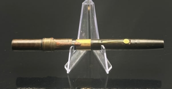 Waterman’s Ideal Fountain Pen, Ripple Hard Rubber, Lever Filler, 14K Gold Nib, c.1909, Made in: Remarkable early Waterman’s Ideal Fountain Pen, crafted from rich brown-and-black ripple hard rubber with gold-filled clip and lever engraved “IDEAL.” Barrel stamped “PATENTED AUG. 9 1906
