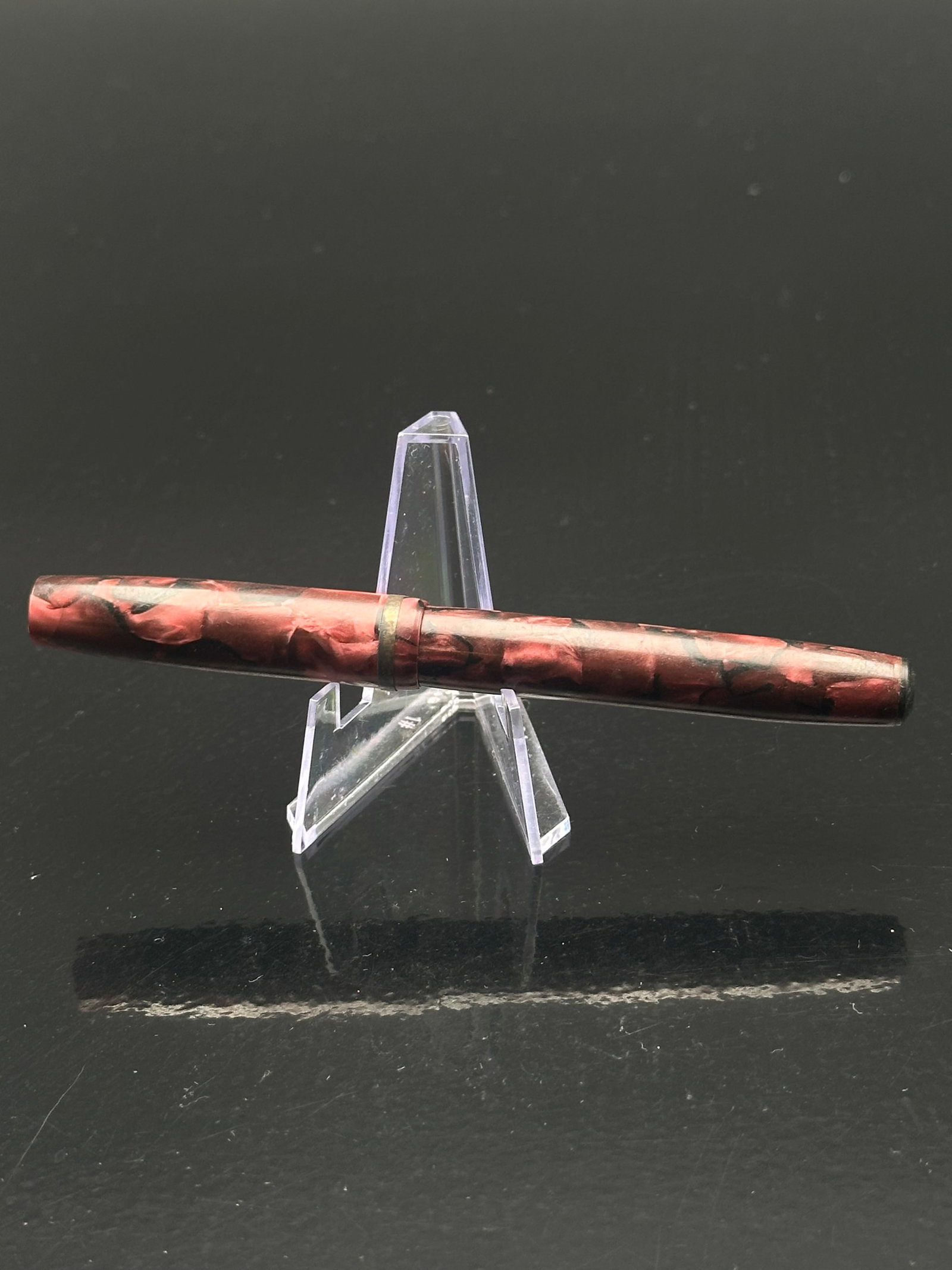 Vintage Red Marbled Fountain Pen – Silver Palladium Alloy Nib, USA, 1940s: A striking vintage red marbled fountain pen featuring a vibrant celluloid barrel and cap with black section and trim. The nib is stamped “Silver Palladium Alloy U.S.A.”, an alloy developed as