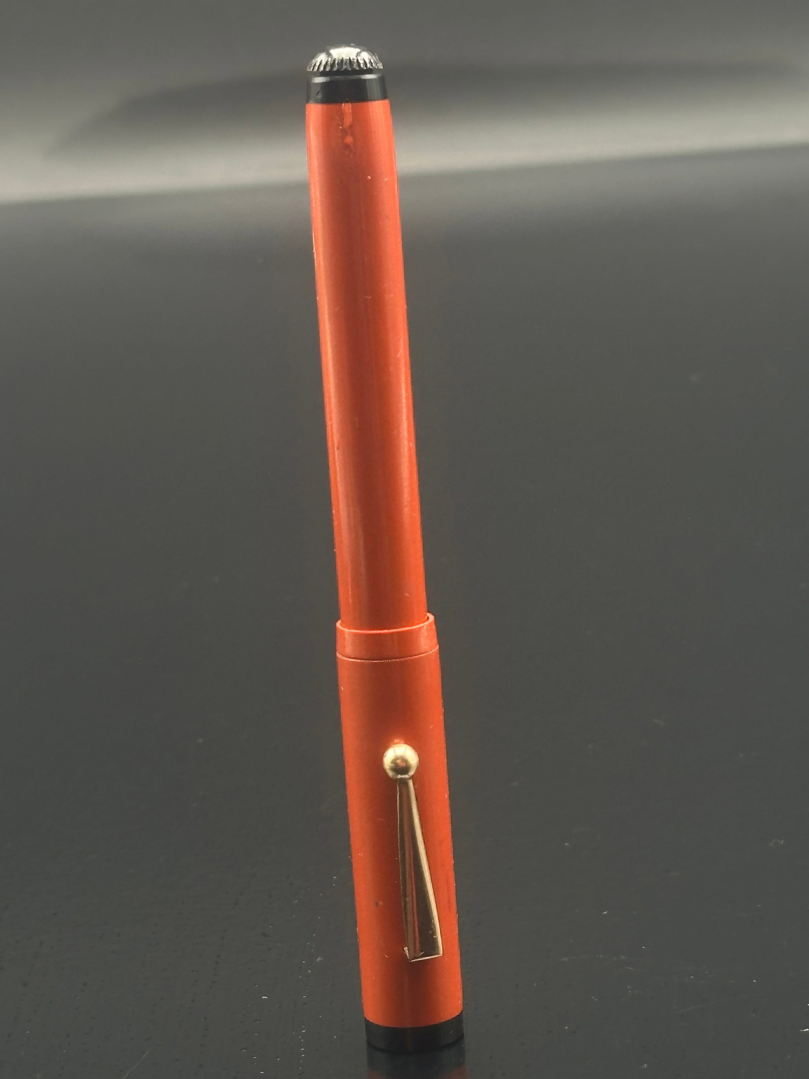 Vintage Ingersoll Newark Fountain Pen – Orange Hard Rubber with 14K Gold Nib: A striking vintage Ingersoll fountain pen, manufactured in Newark, New Jersey, featuring a bright orange hard rubber body with a black hard rubber cap top marked “CHAS. H. Ingersoll Newark.” T