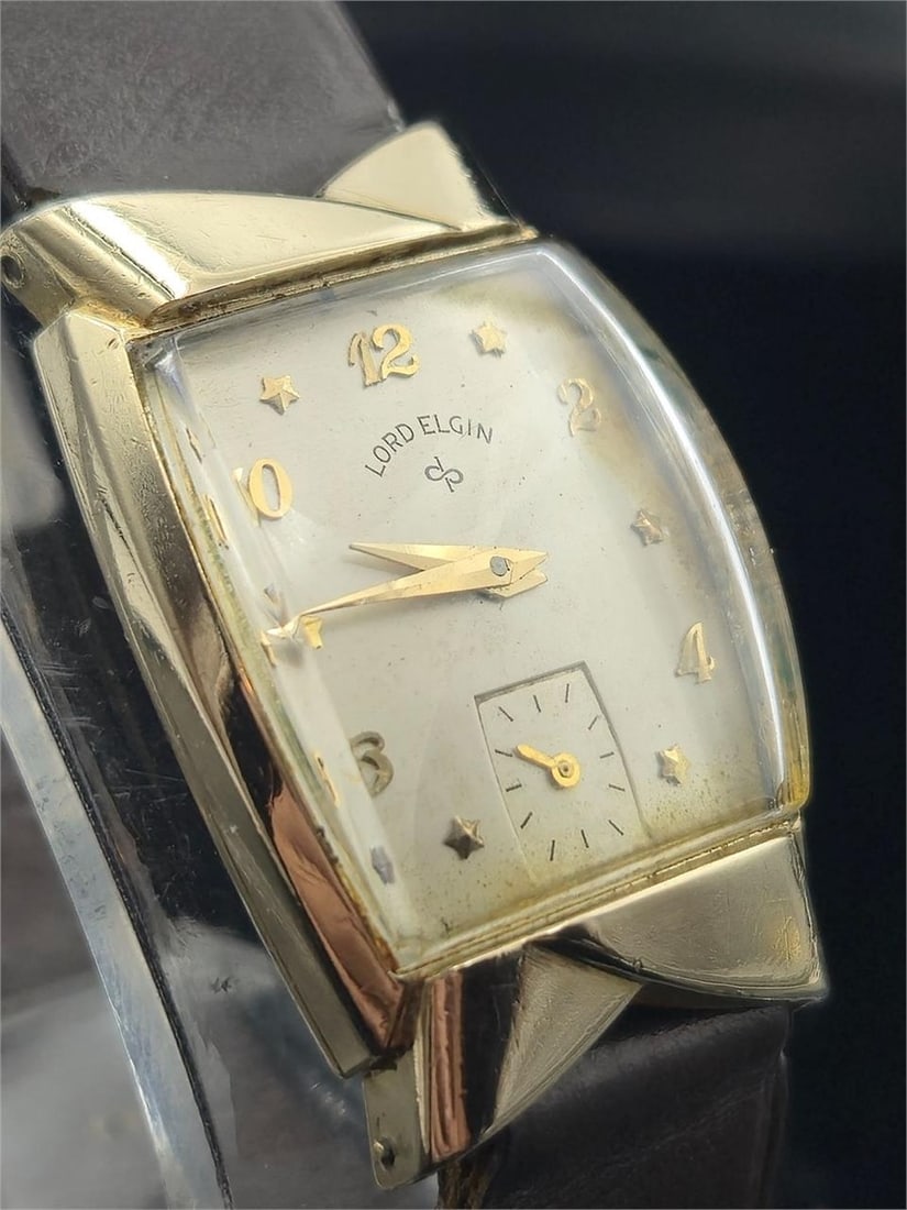 Lord Elgin Star Dial – 14K GF 21J Cal. 670 Watch: Elegant vintage Lord Elgin men’s dress watch featuring a 14K gold-filled case and rare starburst dial design. Powered by the high-grade 21-jewel Elgin Caliber 670 manual wind movement, known for pre