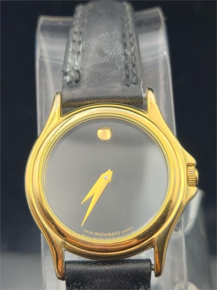 Movado Museum 87-E4-0823 – 29mm Gold Quartz: Vintage Movado Museum Classic wristwatch, reference 87-E4-0823, featuring a 29mm gold-tone case and iconic black Museum dial with gold dot at 12 o’clock. Powered by a reliable Swiss quartz movement.