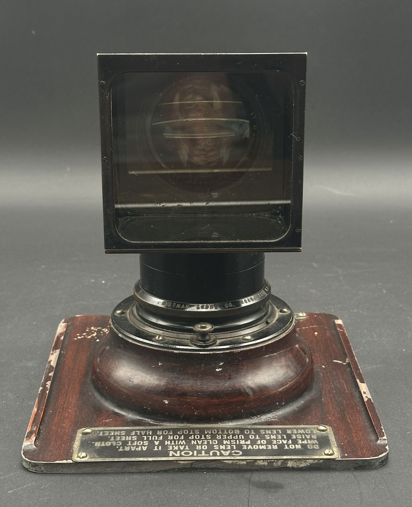 Vintage Eastman Kodak Projection Lens Assembly on Wood Base, Rochester NY: Early Eastman Kodak Co. projection lens assembly, mounted on original wood base with metal plate reading caution and adjustment instructions. Features original black enamel finish, adjustable lens col