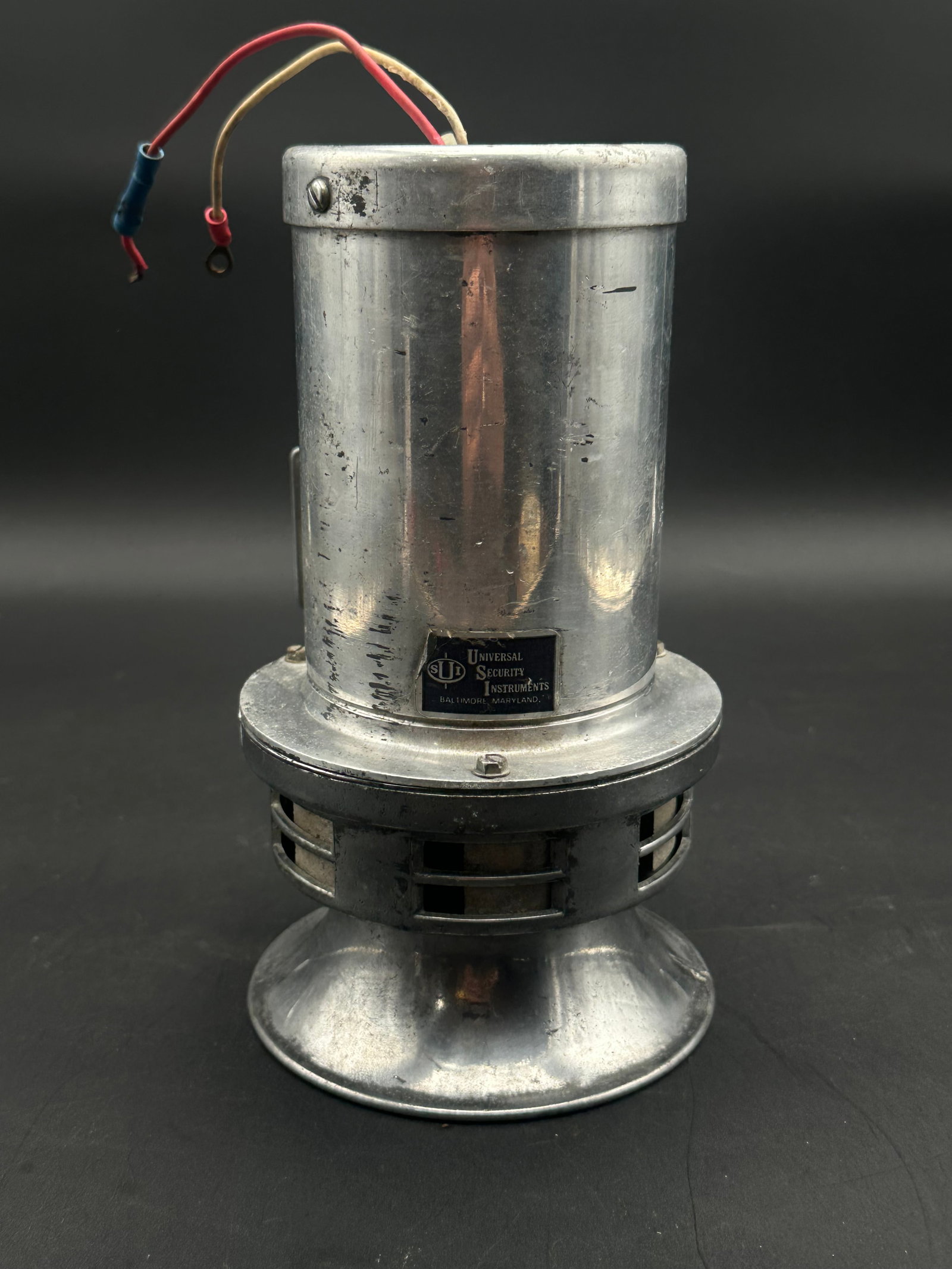 Vintage Universal Security Instruments Alarm Siren – Baltimore, MD: Mid-century industrial alarm siren by Universal Security Instruments, Baltimore, Maryland. Heavy cast and machined aluminum housing with vented base and dual-wire connection. Likely used for building 