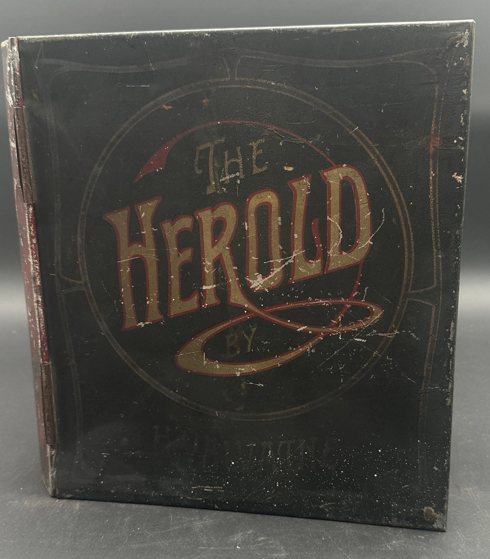Early 1900s “The Herold Smoked Sardines” Norwegian Advertising Tin: Rare lithographed tin advertising box for “The Herold Smoked Sardines,” packed by H. Valvatne, Sunde, Norway. Book-form design with hinged lid, interior storage, and detailed graphic of sardin