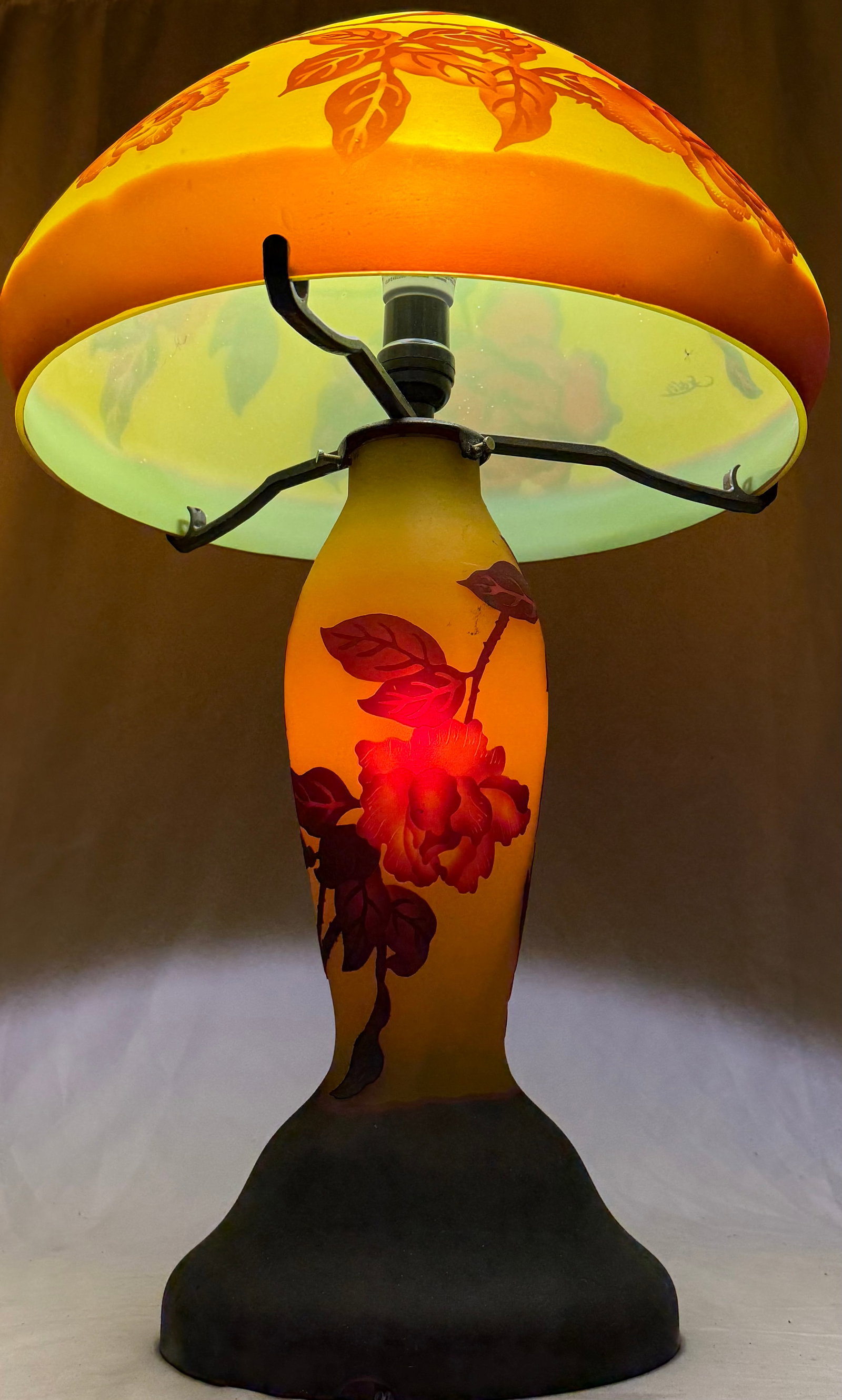 Reproduction of Emile Galle, French (1846-1904) Art Nouveau Cameo Glass Lamp: Reproduction of Emile Galle, French (1846-1904) Art Nouveau Cameo Glass Lamp. Orange and brown color ground with raised flower relief. Signed Galle on shade. Good condition.