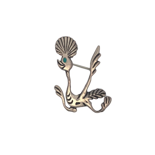 Vintage Sterling Silver Roadrunner Brooch with Turquoise Eye and Hand Stamped Details, 9.7g: Charming vintage sterling silver brooch depicting a stylized roadrunner, accented with a single turquoise cabochon eye. The body features delicate hand-stamped feather and tail detailing, capturing th