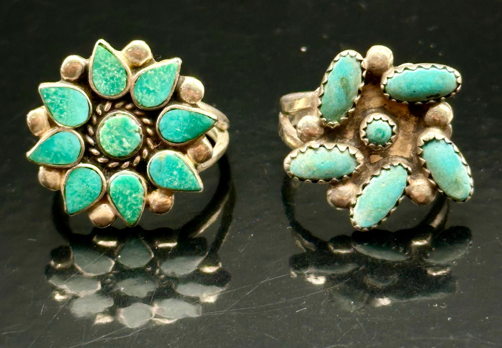 Pair of Vintage Zuni Turquoise Cluster Sterling Rings – 8g: Pair of vintage Southwestern Zuni-style sterling silver rings, each featuring hand-cut turquoise cabochons in traditional cluster arrangements.• One ring has a floral pattern with teardrop turquo