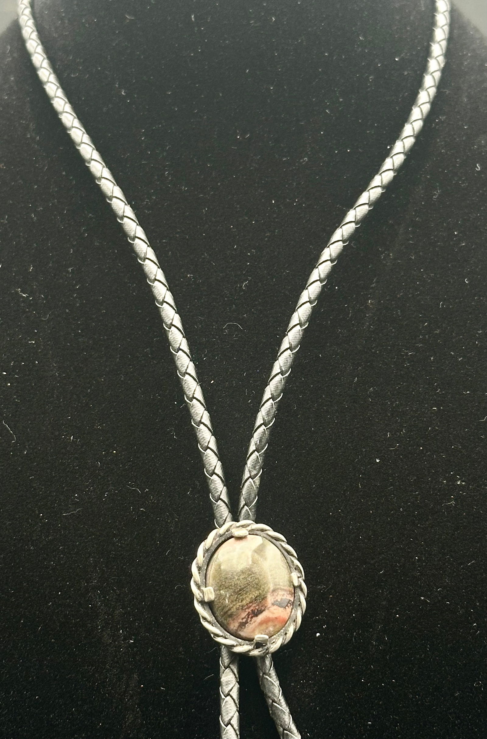 Vintage Sterling Silver Picture Jasper Bolo Tie: Classic vintage sterling silver bolo tie featuring an oval picture jasper cabochon with natural brown, tan, and pinkish veining. Stone set in a twisted rope silver bezel on a black braided leather cor