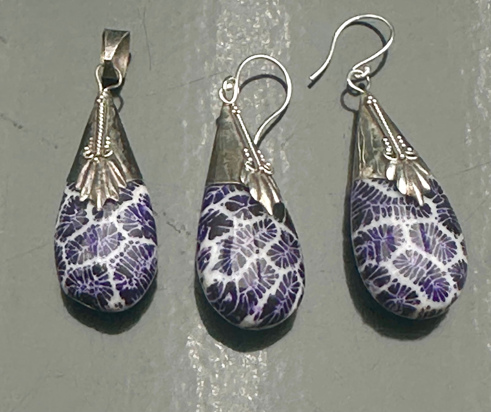Sterling Silver Purple Fossil Coral Pendant & Earring Set, 11g, .925 Marked: Elegant sterling silver jewelry set featuring a pendant and matching drop earrings with polished purple fossil coral stones. Each piece is finished with sleek .925 silver cone caps and ear wires, show