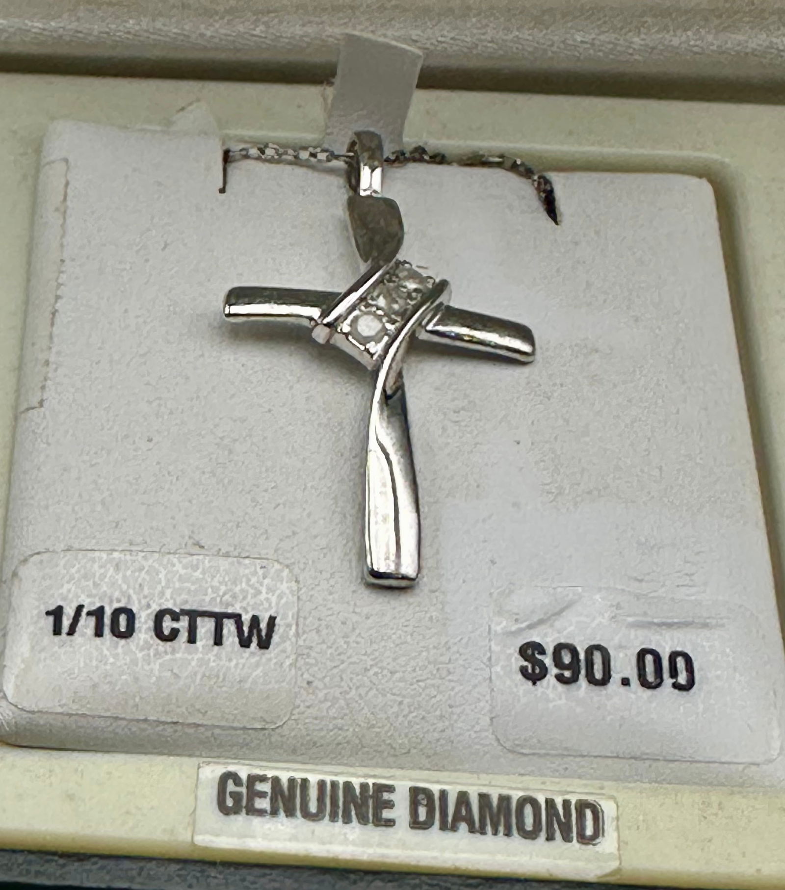 Sterling Silver Diamond Cross Pendant – 1/10 CTTW Genuine Diamonds: Elegant sterling silver cross pendant accented with genuine diamonds totaling approximately 1/10 carat total weight (CTTW). The modern ribbon design adds a contemporary touch while maintaining timeles