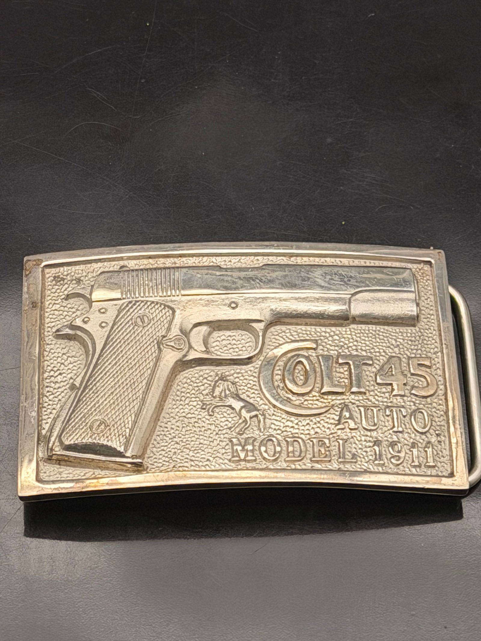 Vintage Adina Sterling Silver Belt Buckle – Colt .45 Auto Model 1911 – 209g: Rare vintage solid sterling silver belt buckle by Adina, featuring a detailed raised design of the classic Colt .45 Auto Model 1911 pistol. Marked ADINA STERLING 0314 on the back. Beautiful craftsmans