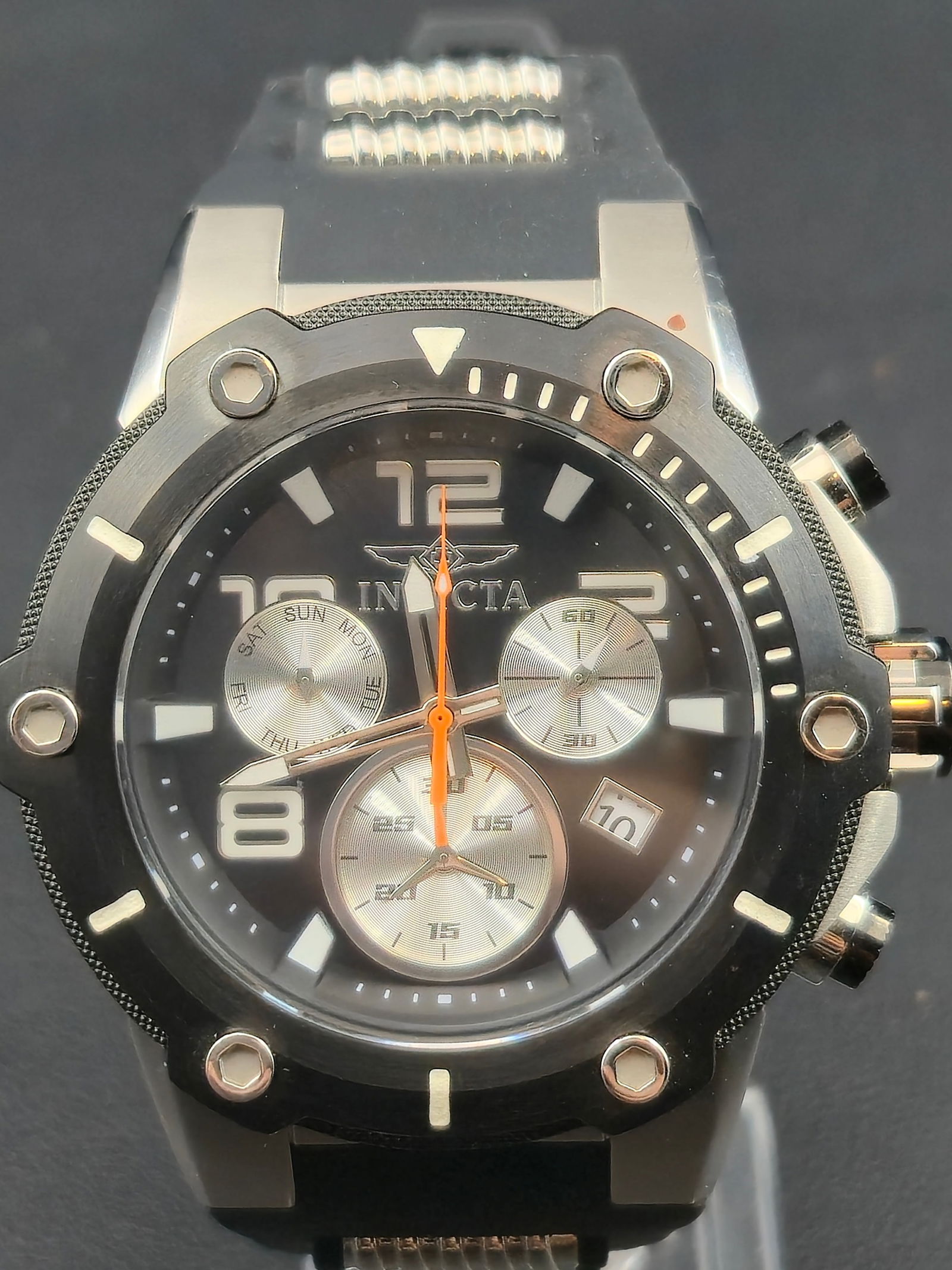 Invicta Speedway Chronograph 52mm Black Dial Stainless Steel New Battery Model 22235: Large and bold Invicta Speedway chronograph wristwatch featuring a 52 millimeter stainless steel case with black and silver dial and orange chronograph seconds hand. Powered by a Swiss Ronda quartz mo
