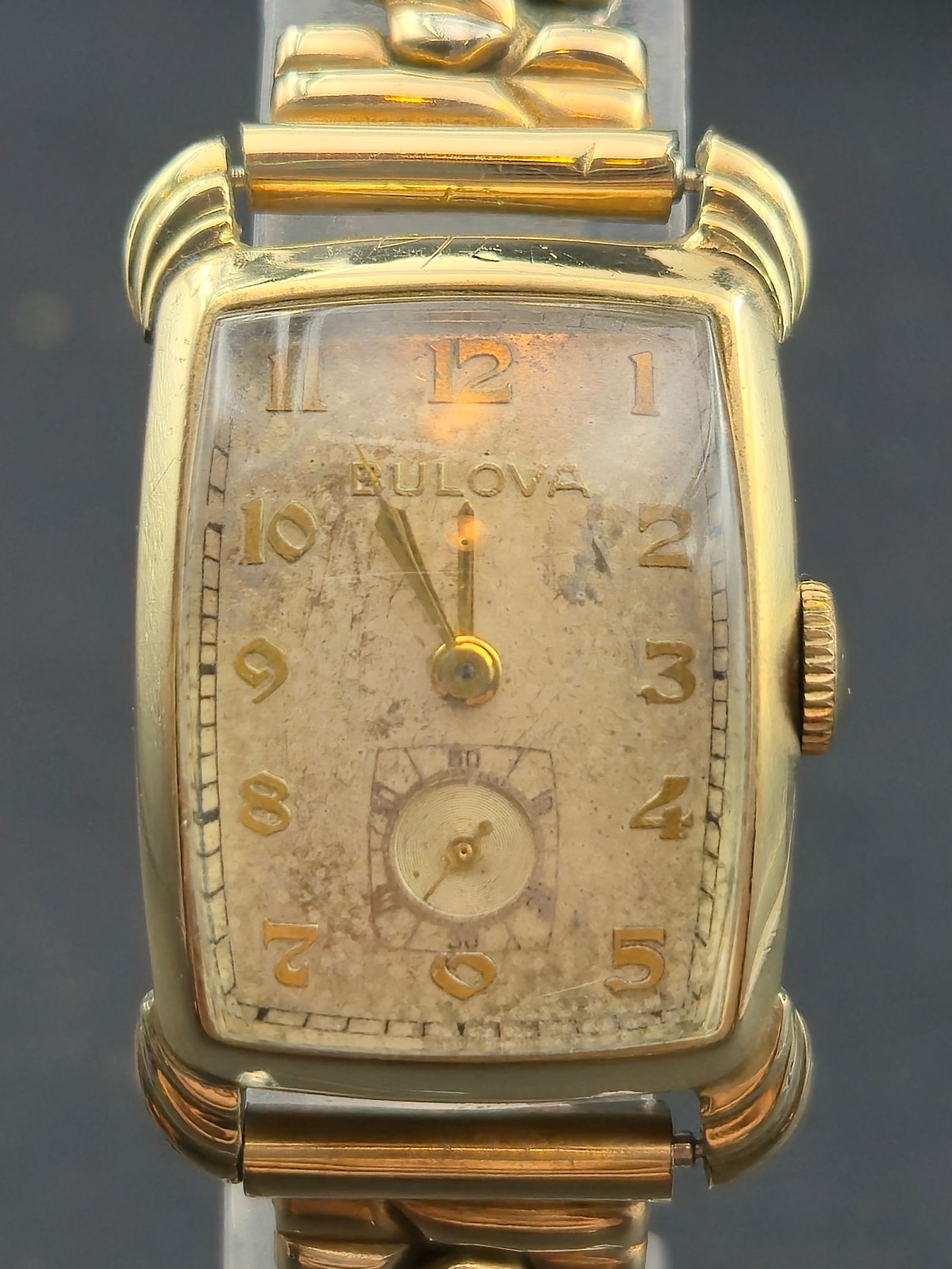 Bulova 8AH 21 mm 17J Manual Wind 10K Rolled Gold Plate Tank Watch (1948) w/ 12K GF Lord Elgin Band: Classic late-1940s Bulova men’s wristwatch, powered by the Bulova 8AH 17-jewel manual-wind movement made in the U.S.A. The rectangular case features a 10K rolled gold plate bezel with stainless-stee