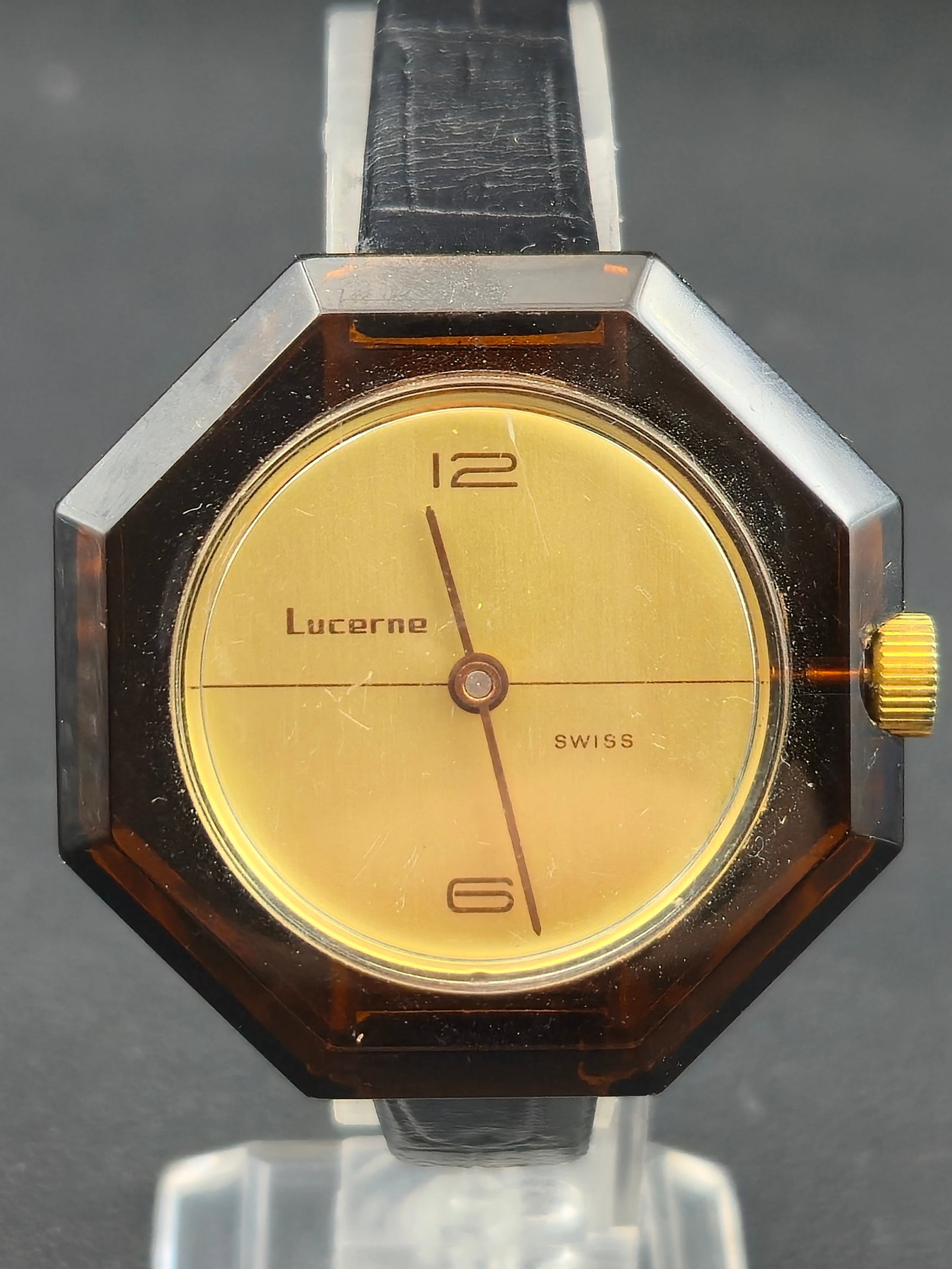 Lucerne Swiss Octagonal Transparent Acrylic Mechanical Watch (c.1970s, 40 mm) – Runs: This vintage Lucerne Swiss wristwatch from the 1970s features a rare octagonal smoked-amber transparent acrylic case, allowing full view of its mechanical movement through both the front and back. The