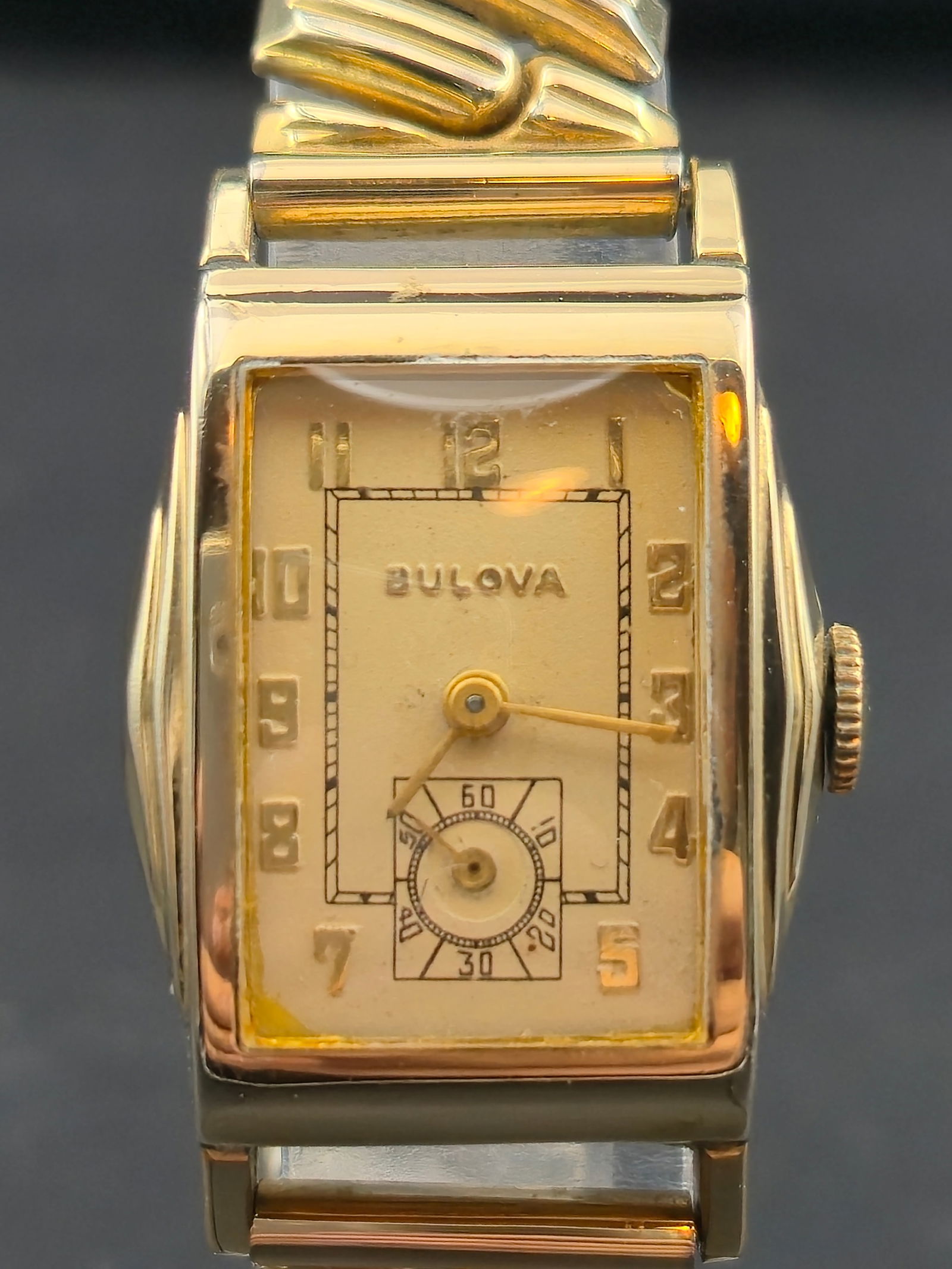 Bulova 23 mm Tank Watch 17 Jewel Mechanical Runs Vintage Two Tone Case and Band: Vintage Bulova tank style wristwatch featuring a gold tone and stainless two tone case, decorative stepped lugs, and original applied numeral dial with small seconds. Powered by a seventeen jewel Bulo