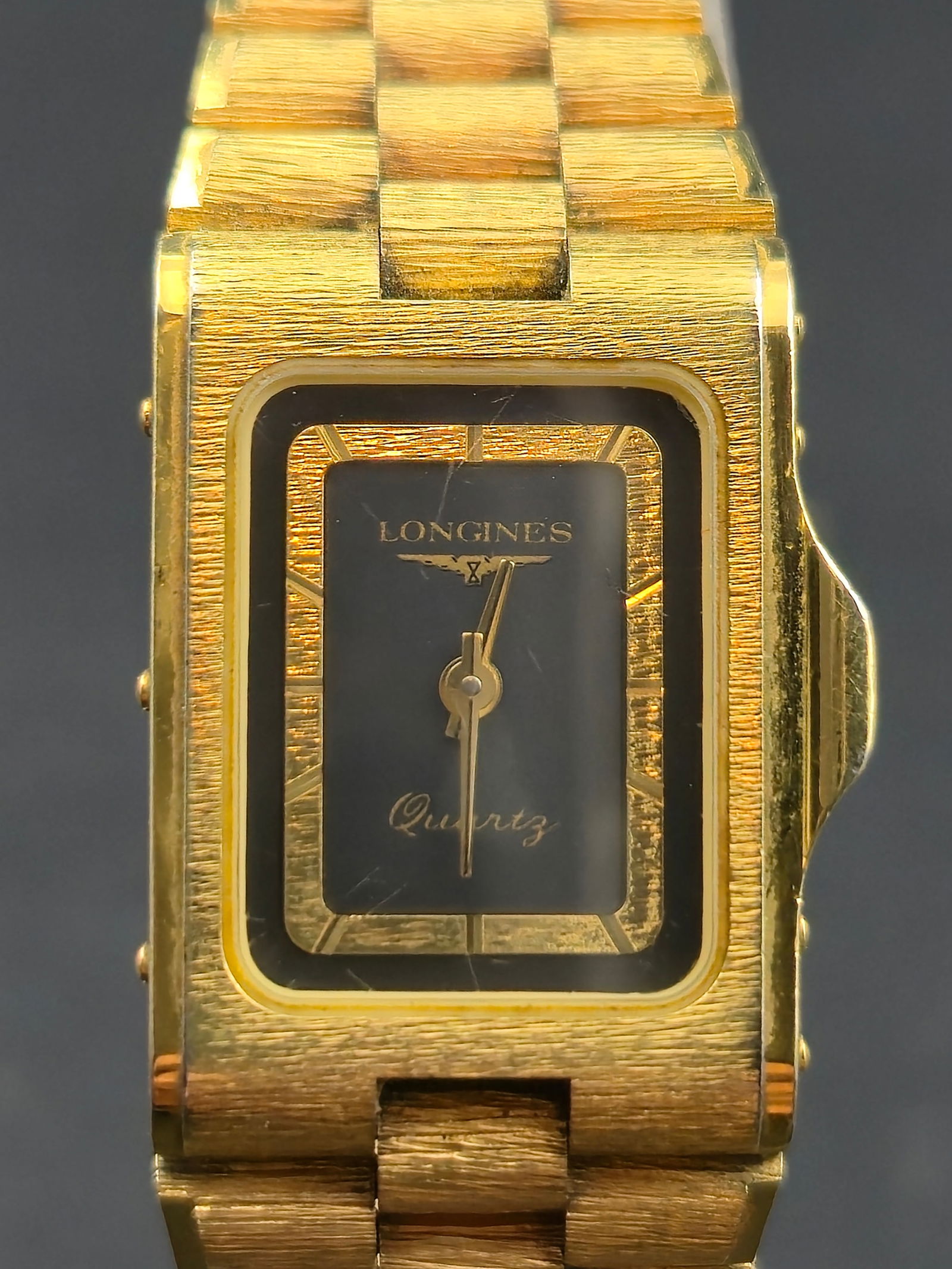 Longines 17 mm Gold Tone Ladies Quartz Watch with Integrated Bracelet Swiss Movement Runs Vintage: Vintage Longines ladies quartz wristwatch featuring a gold tone rectangular case with an integrated matching bracelet. The watch retains its original black and gold dial with the Longines winged hourg