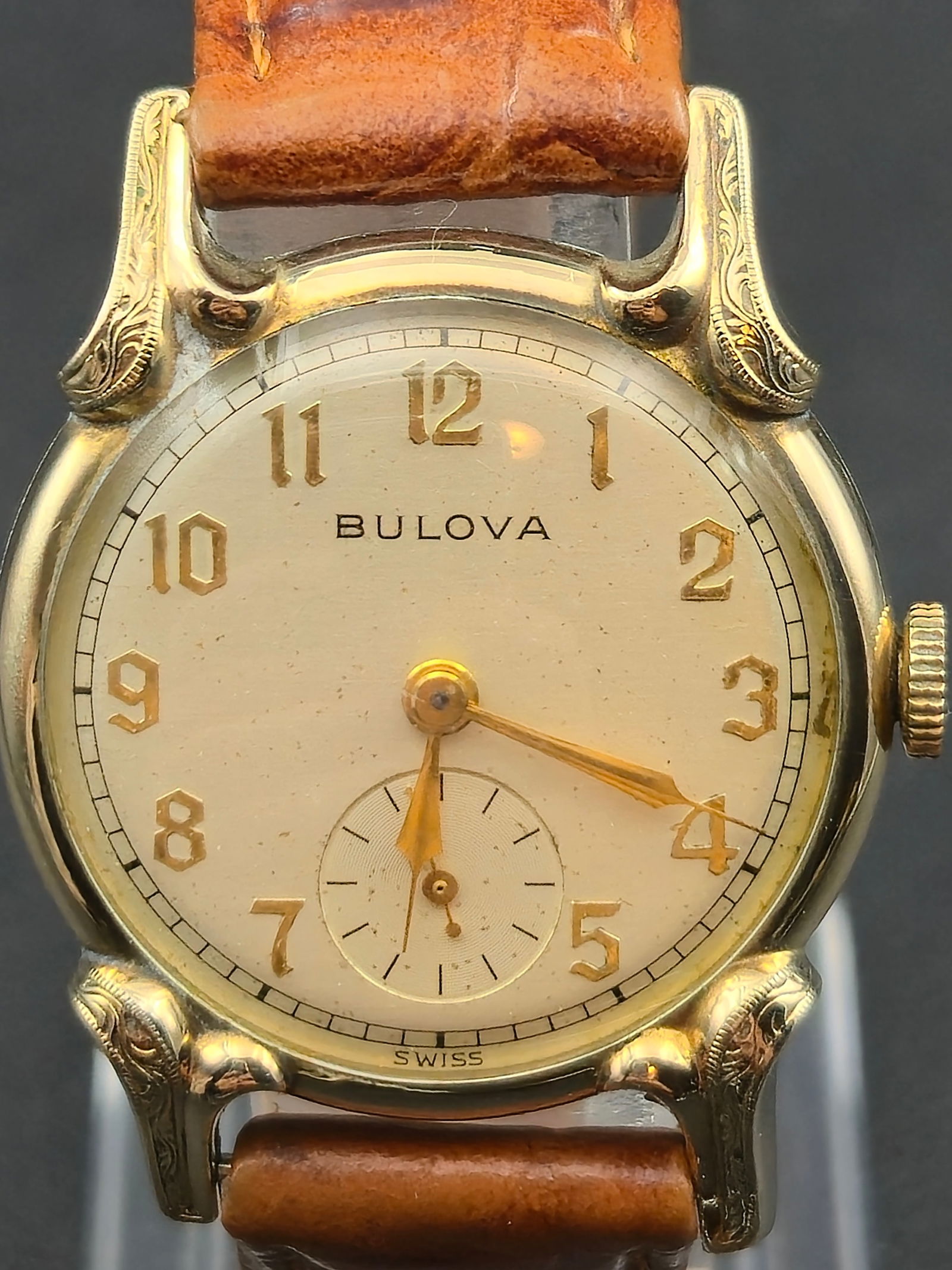 1952 Bulova 10k RGP Engraved Lug Dress Watch 30mm Swiss 10BT Manual Wind Running: Beautiful 1952 Bulova Swiss made dress watch featuring ornate engraved lugs and a classic gold tone dial with applied numerals. This example retains its original signed crown and houses the Bulova 10B