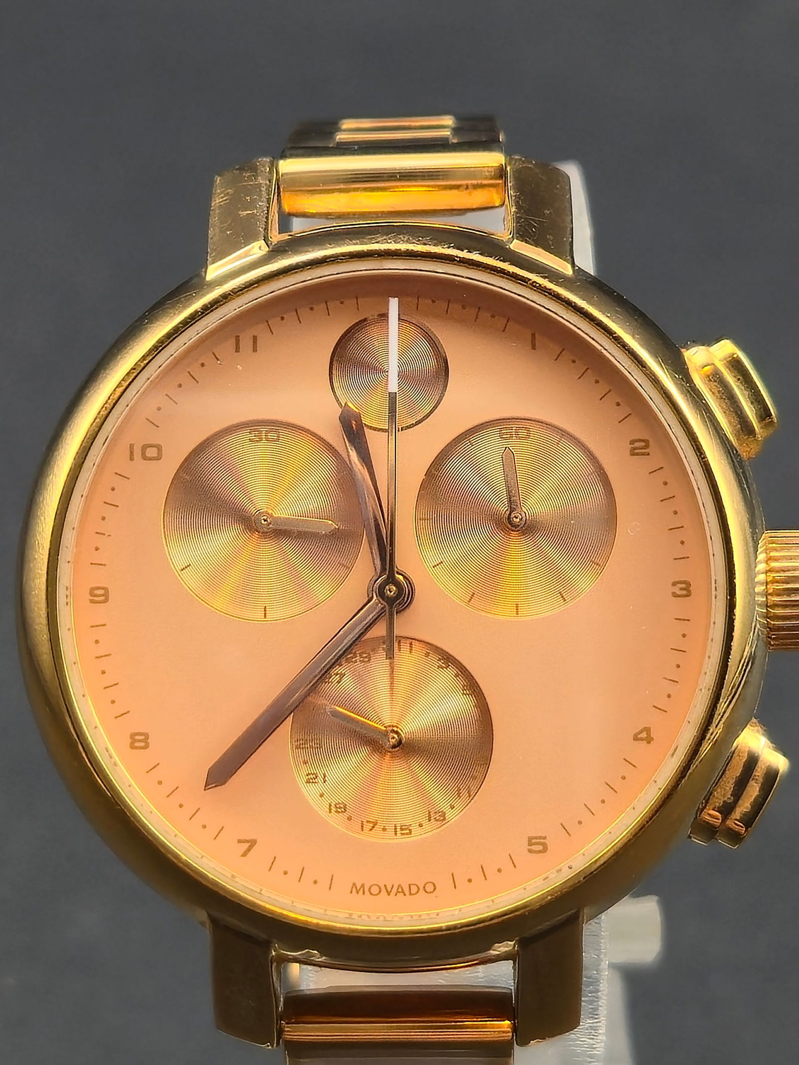 2019 Movado Bold 34mm Rose Gold Tone Swiss Chronograph New Battery Stainless Bracelet Runs: Striking 2019 Movado Bold Chronograph Model 126.5 finished in a rich rose gold tone, featuring a stainless steel case and bracelet with a warm rose finish. The sunray-pattern dial carries matching ros