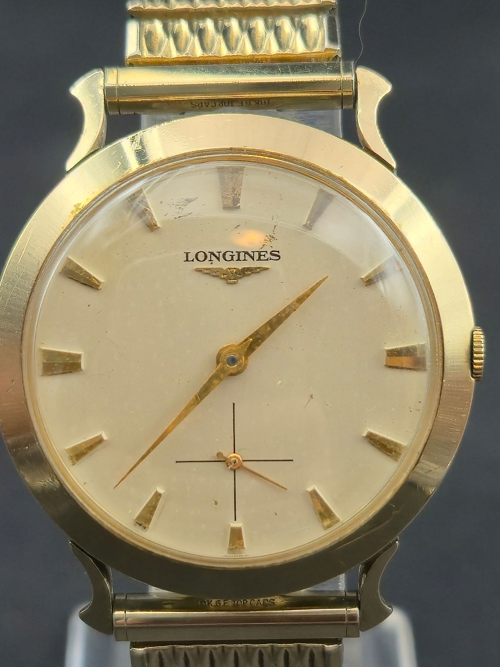 1950s Longines 10K GF 34 mm 17J 27M “Fancy Lugs” Vintage Dress Watch: Vintage 1950s Longines wristwatch featuring the Longines 27M manual-wind movement with 17 jewels and a 10K gold-filled case by Longines-Wittnauer. Classic minimalist dial with applied markers and dist