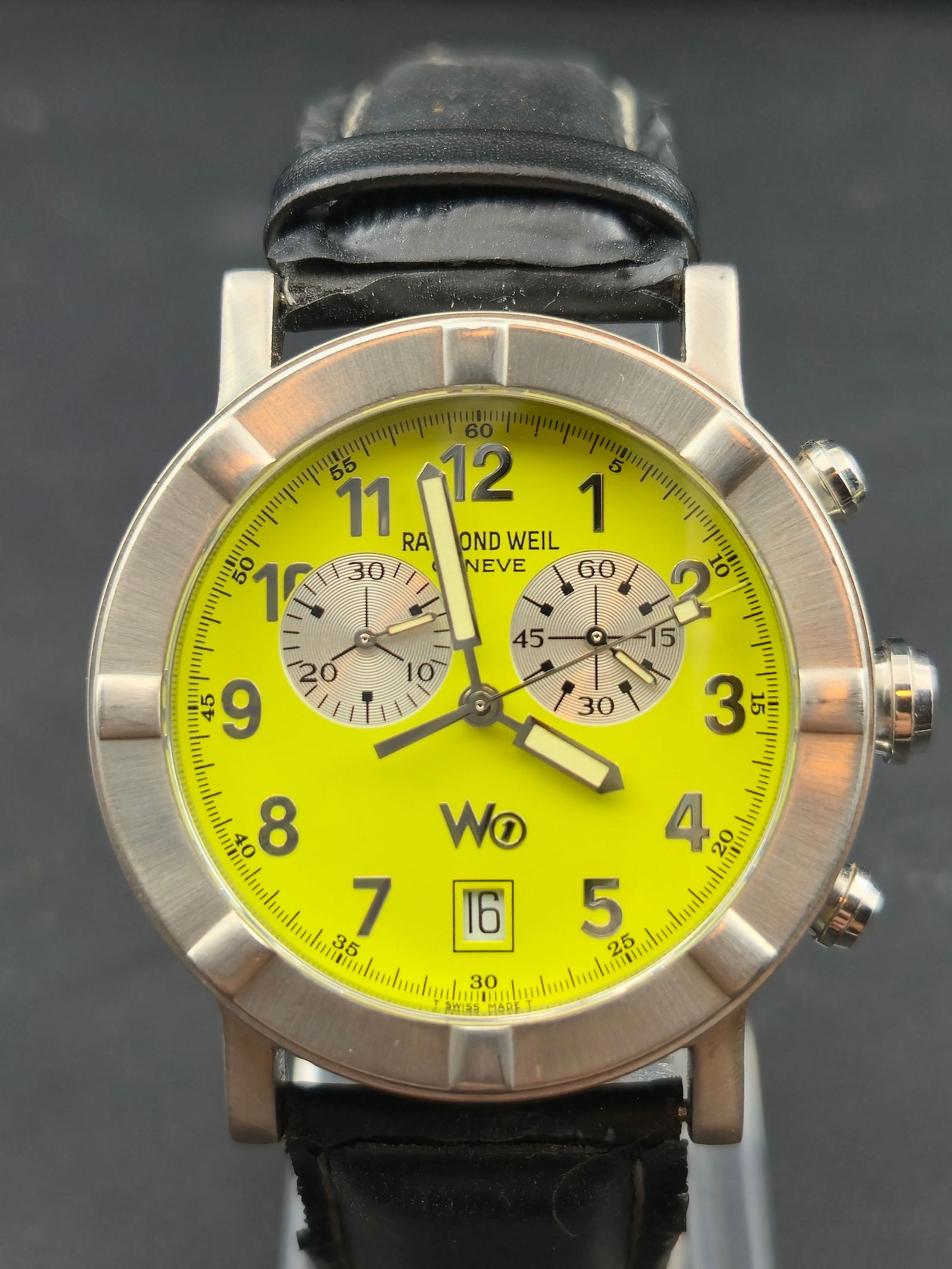 Raymond Weil W1 Chronograph Neon Green Dial Stainless Steel Full Set 38mm: This Raymond Weil W1 Chronograph features the rare neon green dial with dual subdials, date display, and original Raymond Weil signed leather strap. Includes the full original W1 presentation canister
