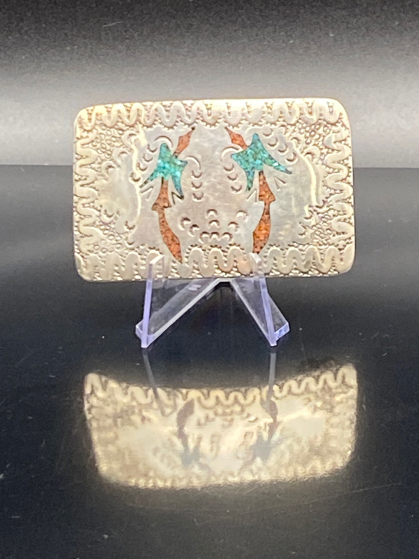 Vintage Southwestern Brass Belt Buckle w/ Turquoise & Coral Inlay: Beautiful vintage Southwestern–style belt buckle featuring natural turquoise and red coral cabochons. The buckle is made of brass with hand-tooled stamped designs, a rope-twist border, and raised le