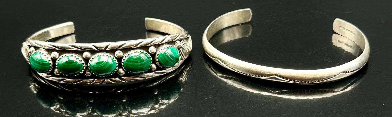 Vintage Sterling Malachite Row Cuff & Simple Sterling Cuff – 33g Total: Nice pair of vintage sterling silver cuffs.• Malachite row cuff with 5 green stones and stamped sterling.• Simple sterling cuff with stamped edge design, also marked sterling.Combined weight