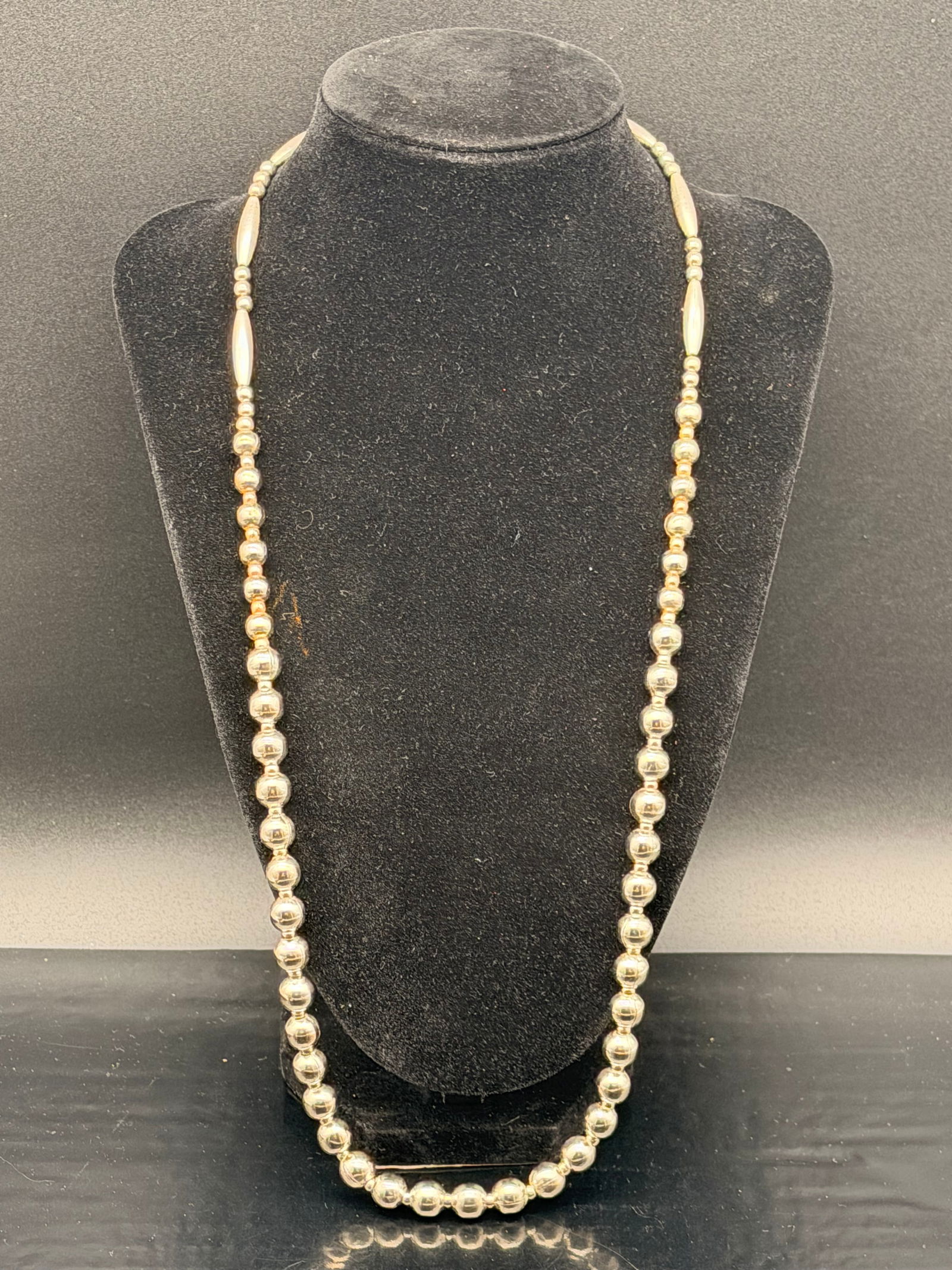 Vintage Navajo Sterling Silver Bead Necklace – 49g: Beautiful vintage Navajo-style necklace featuring graduated sterling silver beads with long tubular accents. Hand-strung, Southwestern design.