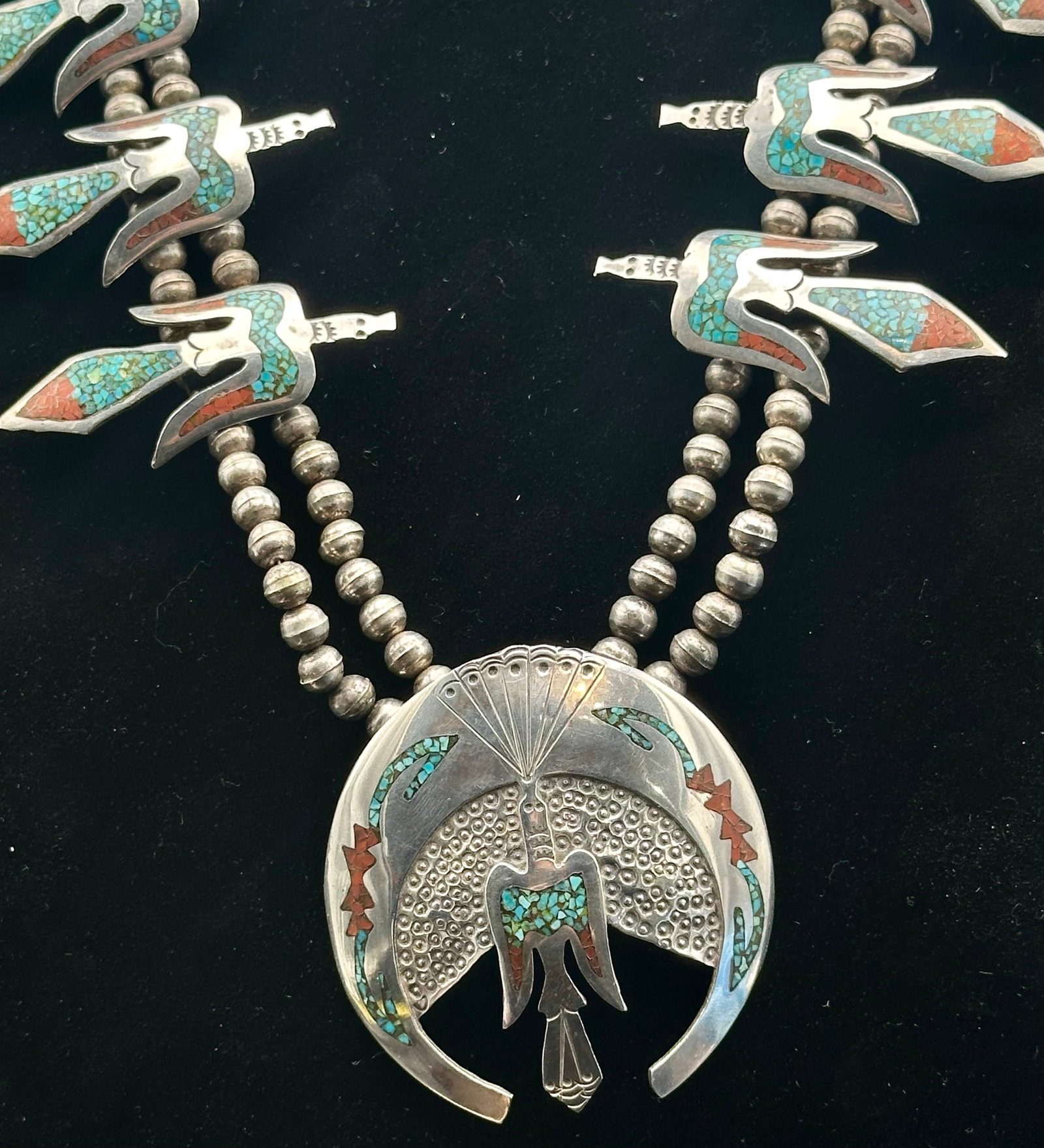 Vintage Navajo-Style Sterling Turquoise & Coral Inlay Thunderbird Squash Blossom Necklace – 151g: Beautiful heavy Navajo-style squash blossom necklace with thunderbird inlay stations. Sterling silver beads with turquoise and coral chip inlay. Large matching Naja with stamped details. Great vintage