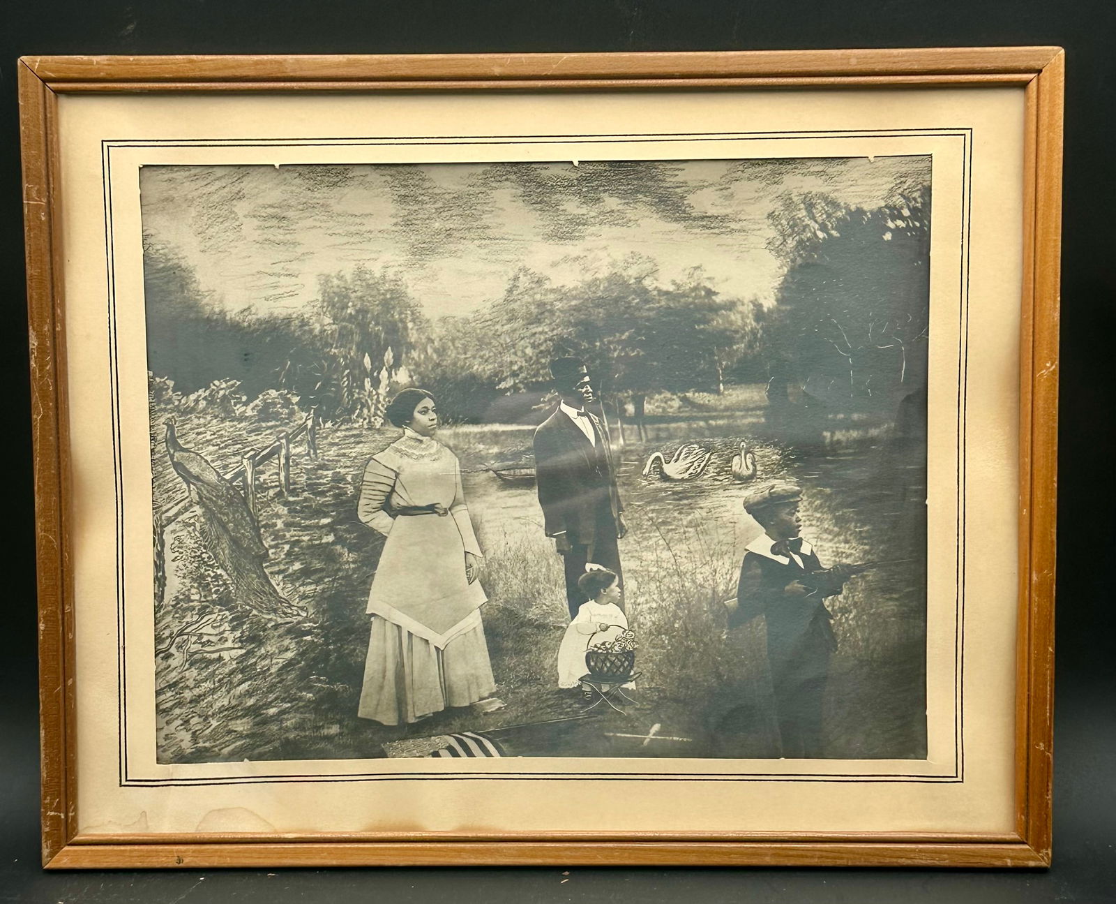 Early 1900s African American Family Print: Vintage early 1900s photographic print featuring an African American family in a Victorian park setting with swans and a peacock. Likely a photogravure or early photo-illustration composite. Sepia/blu
