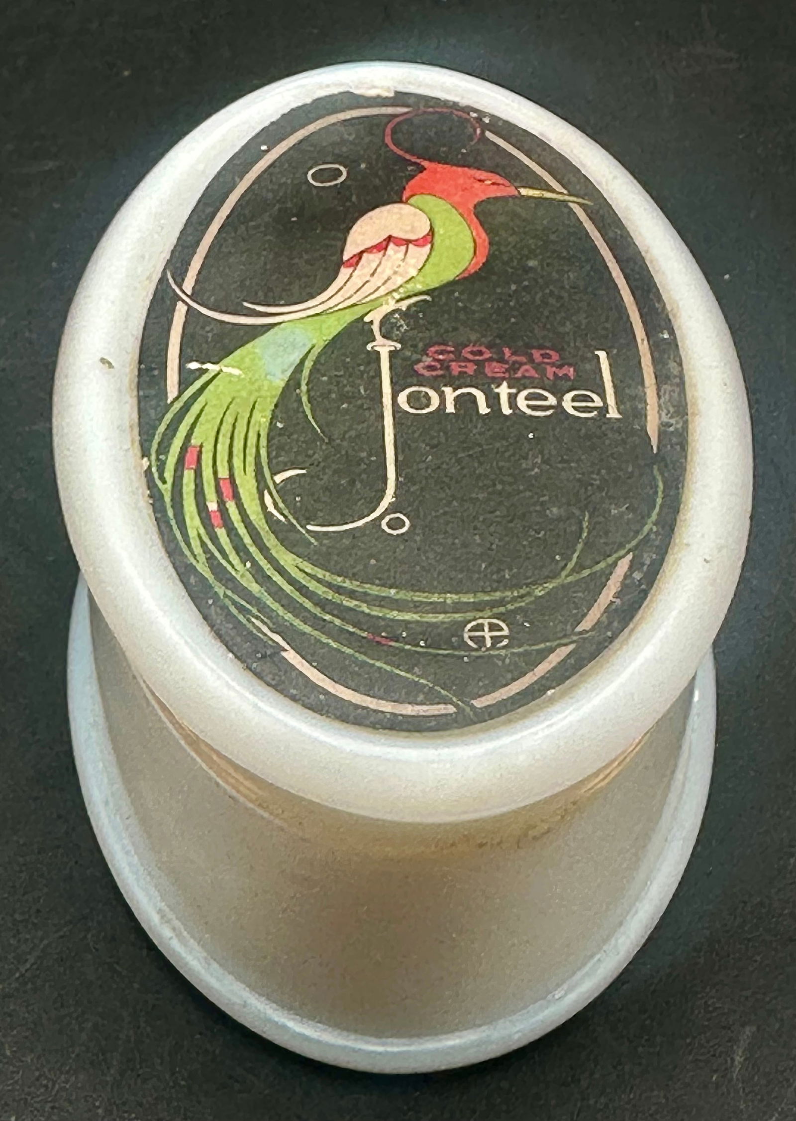 Antique Cold Cream Jonteel Milk Glass Jar w/ Art Deco Peacock Lid: Antique Cold Cream Jonteel milk glass cosmetic jar, c. 1917–1925. Features the beautiful Art Deco peacock graphic on the lid and the original instruction/advertising label on the base. Jar is made o
