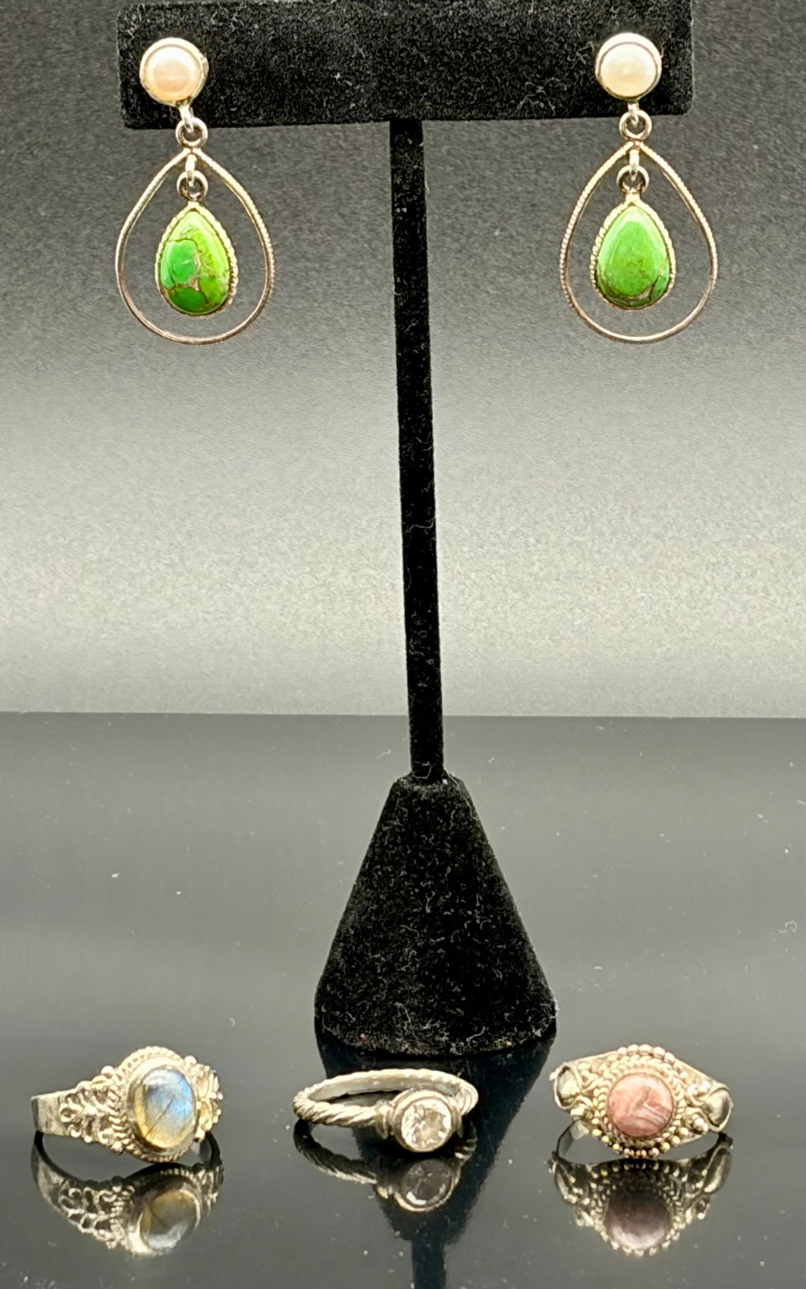 Gemstone Earrings & Three Sterling Rings Lot: Attractive four-piece jewelry lot featuring natural gemstone elements. Includes a pair of dangle earrings with teardrop-shaped green stones suspended from pearl-like studs, creating a bold bohemian ae