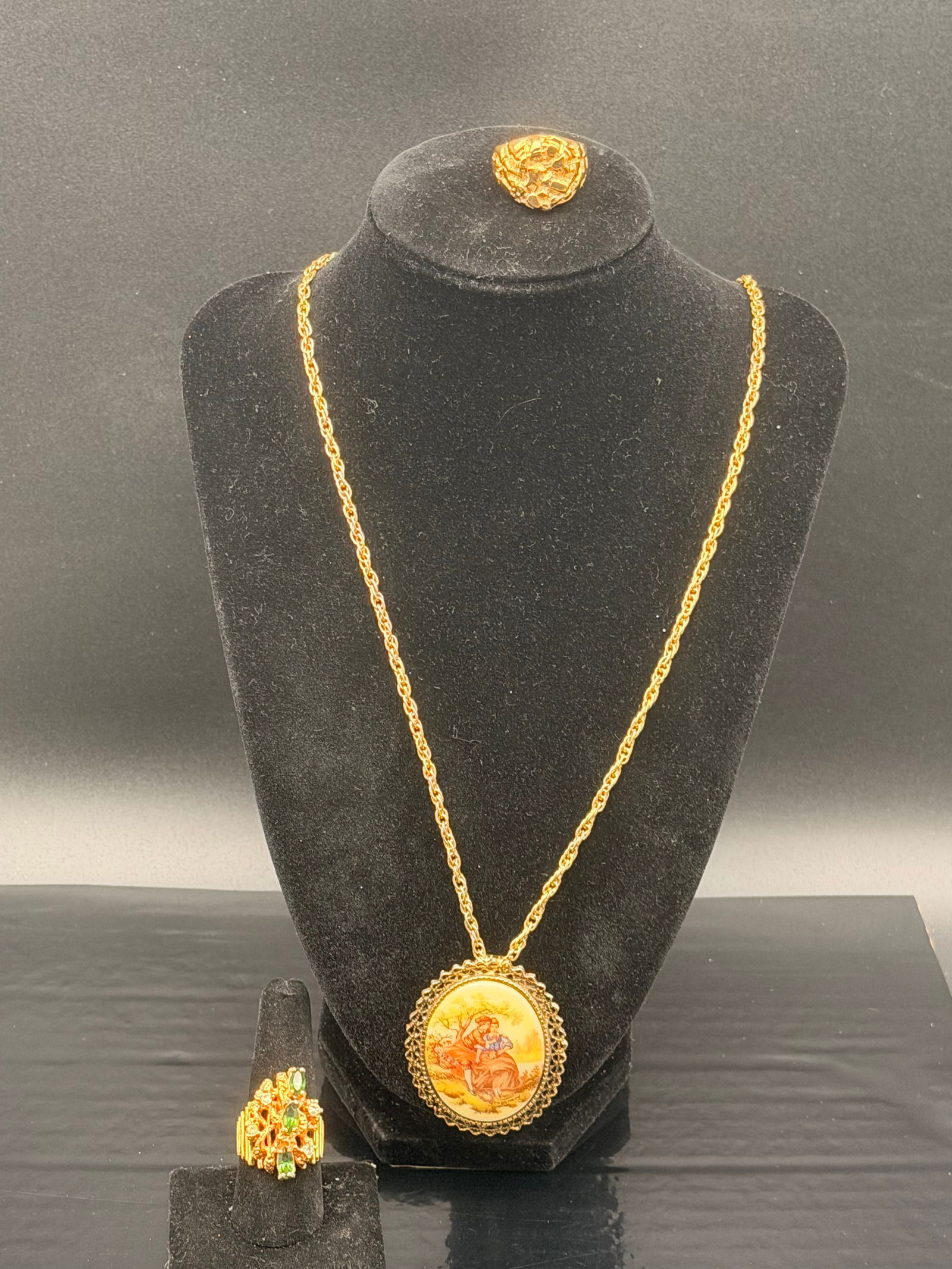 Vintage Hand-Painted Pendant Necklace With 14KT H.G.E. Gold Nugget & Emerald-Style Rings – 3-Piece: Beautiful 3-piece vintage jewelry set featuring a romantic hand-painted cameo-style pendant necklace with a gold-tone chain, paired with two striking 14KT H.G.E. (Heavy Gold Electroplate) rings.