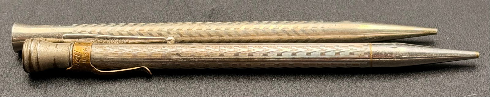 Blaisdell Pencil Co. – Mechanical Pencil (Early 1900s), Sheaffer’s – Mechanical Pencil: Early 1900s Blaisdell Pencil Co. mechanical pencil, featuring a gold-filled barrel with etched geometric patterns and the original Blaisdell clip. Shows age patina and wear consistent with its age, bu