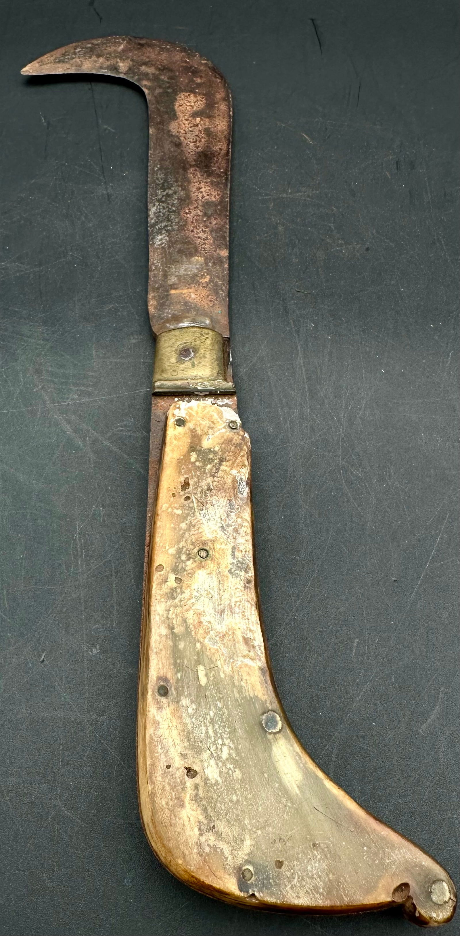 Antique Mediterranean Clasp Knife – Curved Blade, Bone Handle: Antique Mediterranean clasp knife featuring a long curved steel blade, brass bolster, and carved bone handle. Traditional early form used across Southern Europe and the Mediterranean region in the 19t