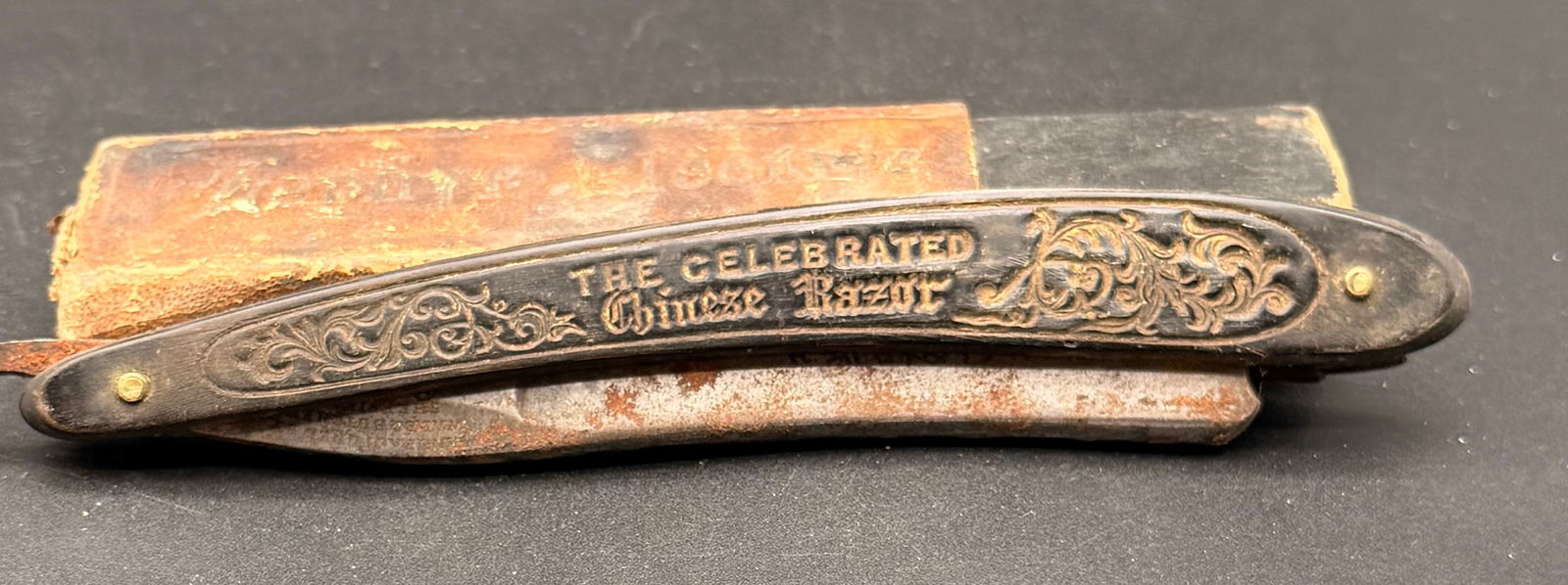 Antique Celebrated Chinese Razor – Wade & Butcher Sheffield – Ornate Handle + Original Box: Antique Wade & Butcher straight razor, marked:•Wade & Butcher – Sheffield•Handle embossed “The Celebrated Chinese Razor” with ornate scrollwork design•Comes with original vint
