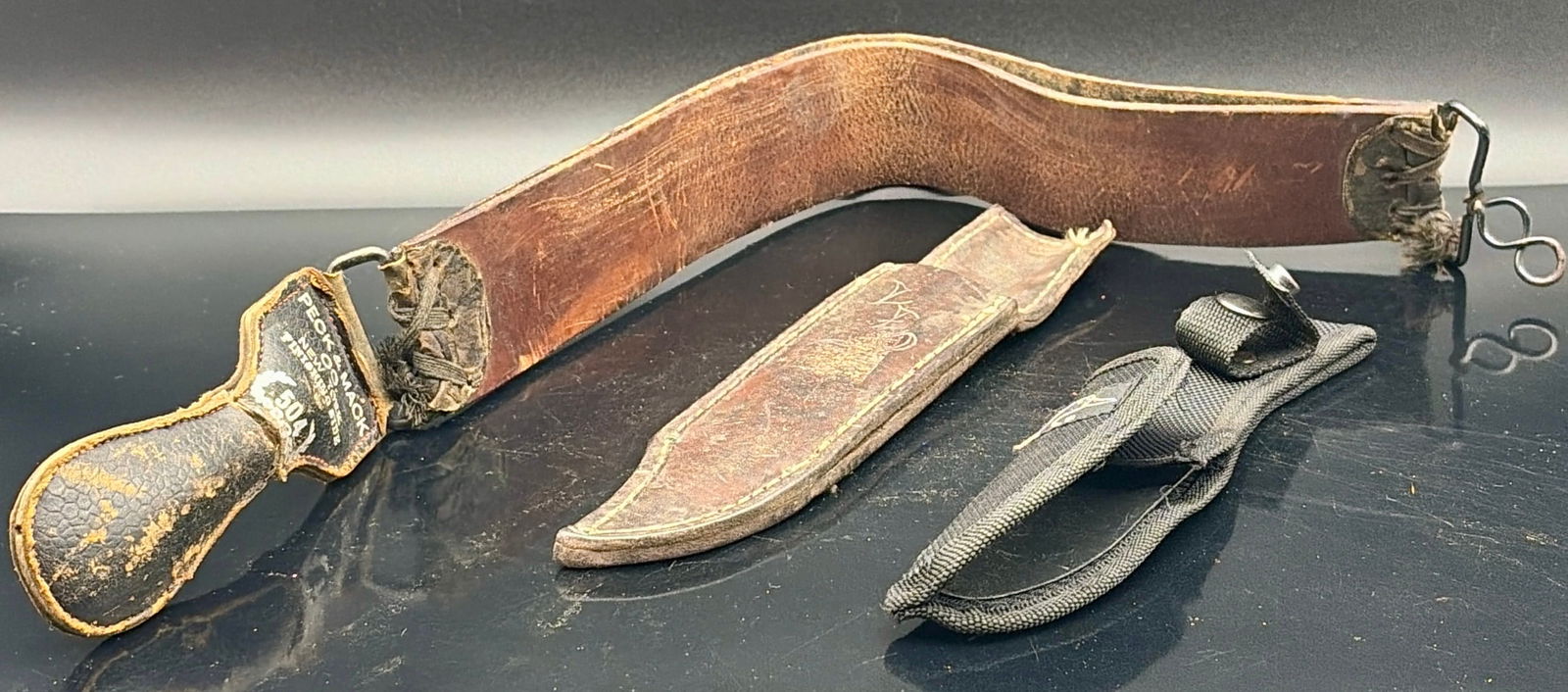 Vintage Leather Knife Belt & Sheaths Lot: Offered is a three-piece vintage leather and nylon accessory lot, ideal for knife collectors, reenactors, or restoration enthusiasts. Includes:1. Vintage Leather Knife Belt / Frog• Thick, curved