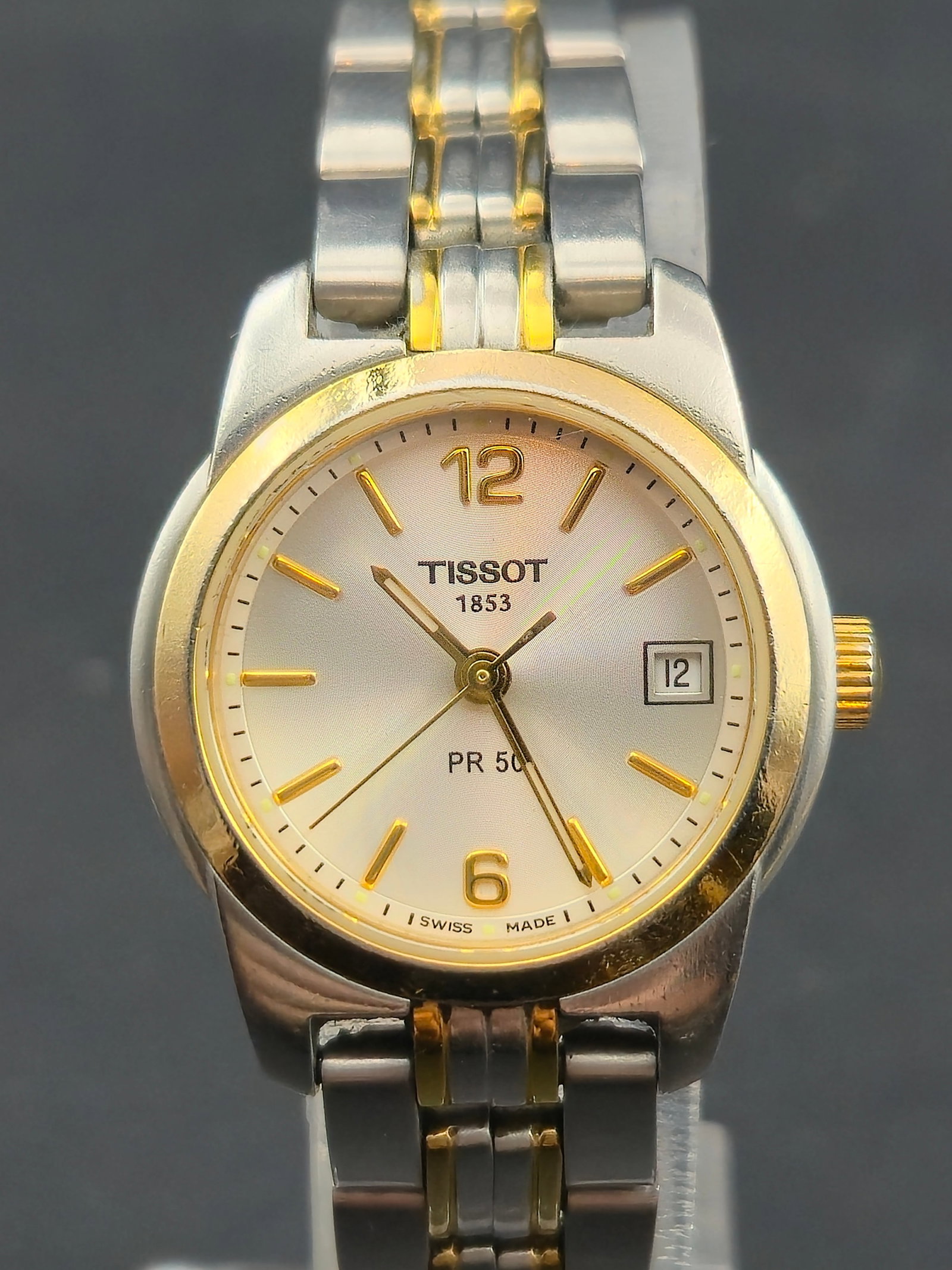 1990s Tissot PR 50 25mm Two-Tone Stainless Quartz Ladies Watch Silver Dial New Battery Running & Kee: Elegant 1990s Tissot PR 50 two-tone ladies quartz wristwatch with a 25mm stainless steel case, gold-tone bezel, and matching bi-color bracelet. Features a silver sunburst dial with gold markers, date