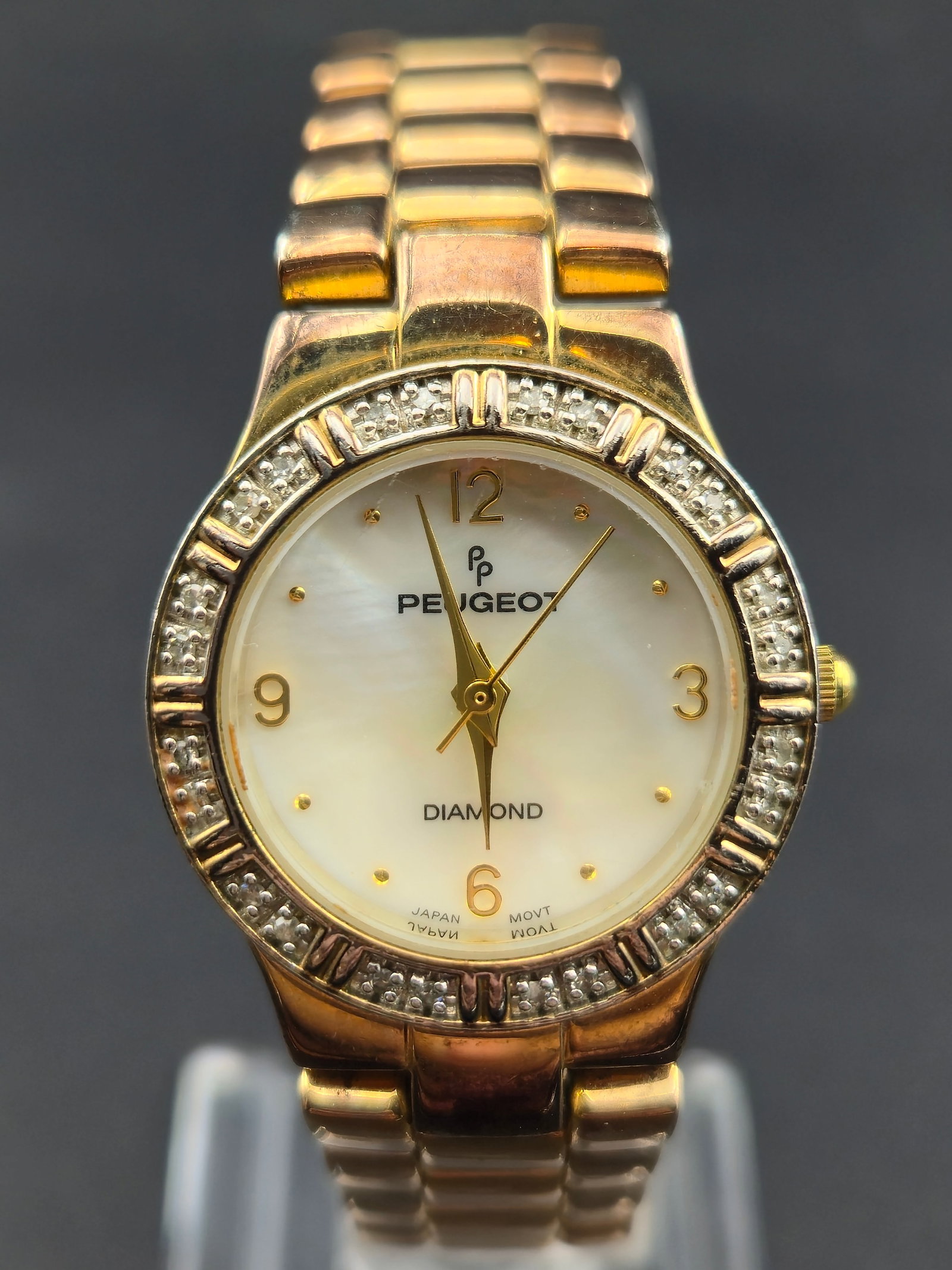 Peugeot Diamond 28mm Gold-Tone Watch Mother of Pearl Dial w/ Box New Battery Running: Elegant Peugeot Diamond ladies’ wristwatch featuring a genuine diamond accent at 12 o’clock, a gold-tone case and bracelet, and a beautiful mother-of-pearl dial. Fresh new battery installed, and t