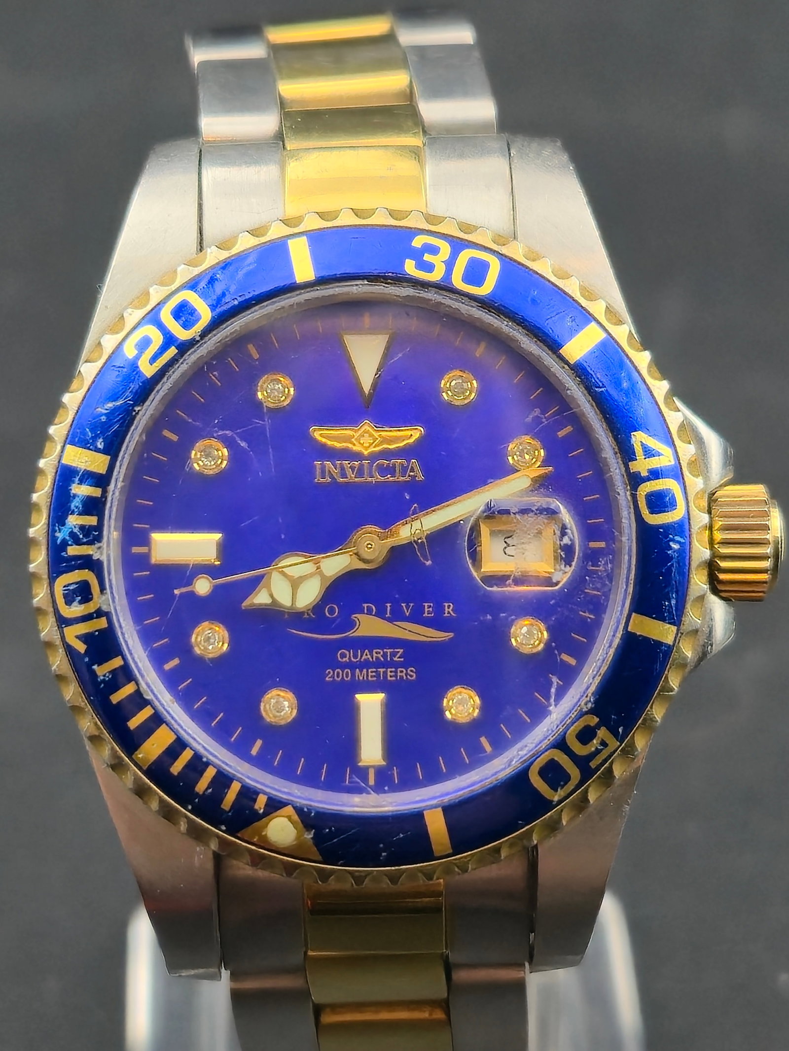 Invicta Pro Diver 5013 Limited Edition Blue Dial Quartz 200M Two Tone New Battery 38mm: This Invicta Pro Diver Limited Edition (number 1840 of 3500) features a striking blue dial with diamond-accent hour markers, two tone stainless steel case and bracelet, and a rotating gold tone diver
