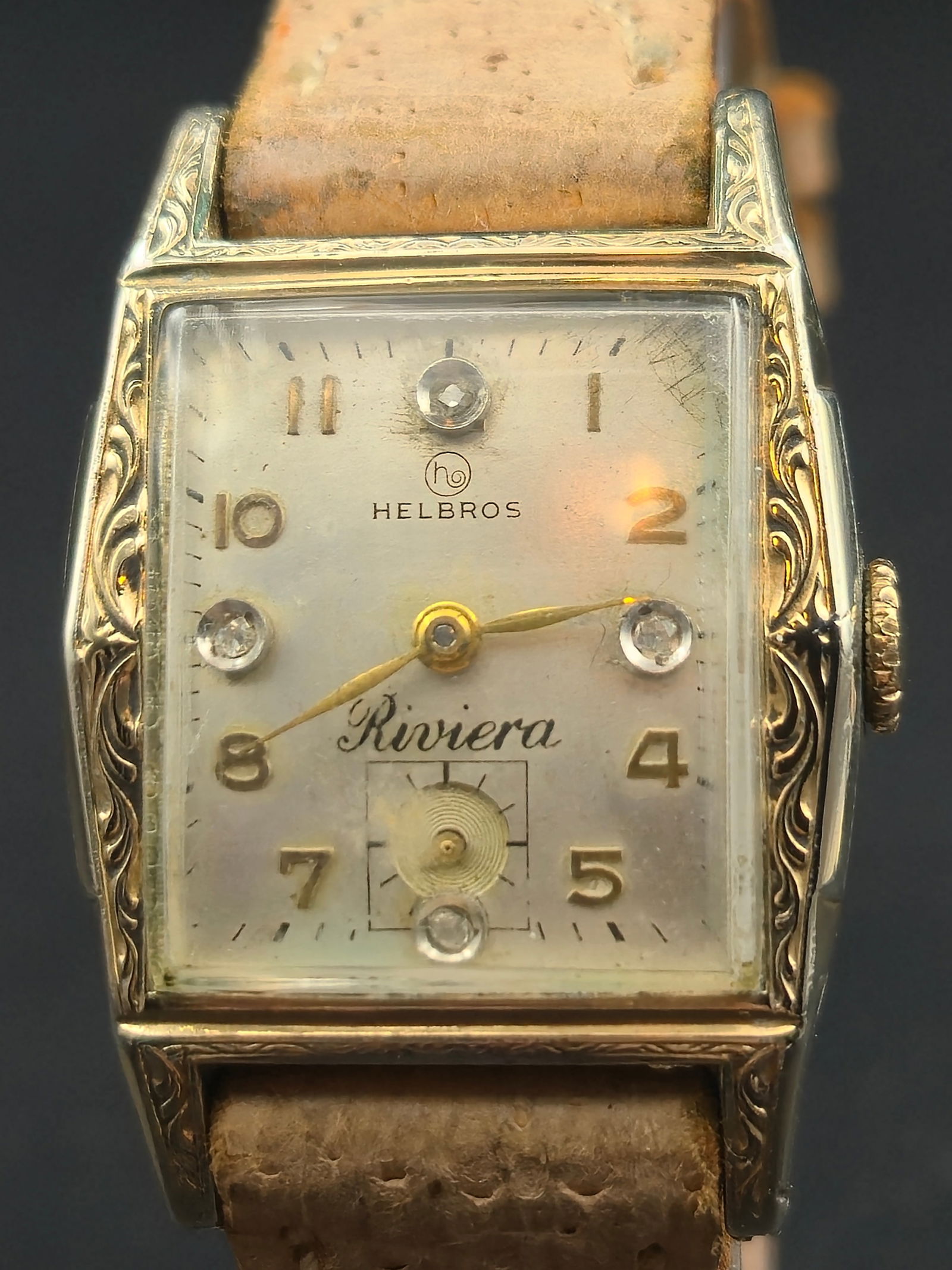 Helbros Riviera 25mm 10K RGP Bezel 17 Jewel Swiss Mens Watch Running: Helbros Riviera wristwatch with a 10K rolled gold plate bezel and stainless steel back. The watch has a light toned dial with decorative markers and sub seconds. The watch is running. Visible aging to