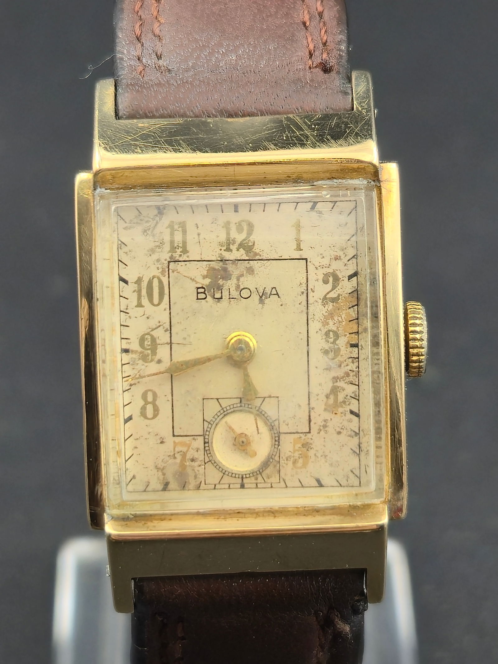Bulova 21mm 10K Gold Filled 21 Jewel Mens Watch Running: Bulova wristwatch with 10K gold filled case and light toned dial with sub seconds. The watch is running. Wear to dial, case, and crystal is visible. Service recommended.DETAILSBrand: BulovaCase Size: