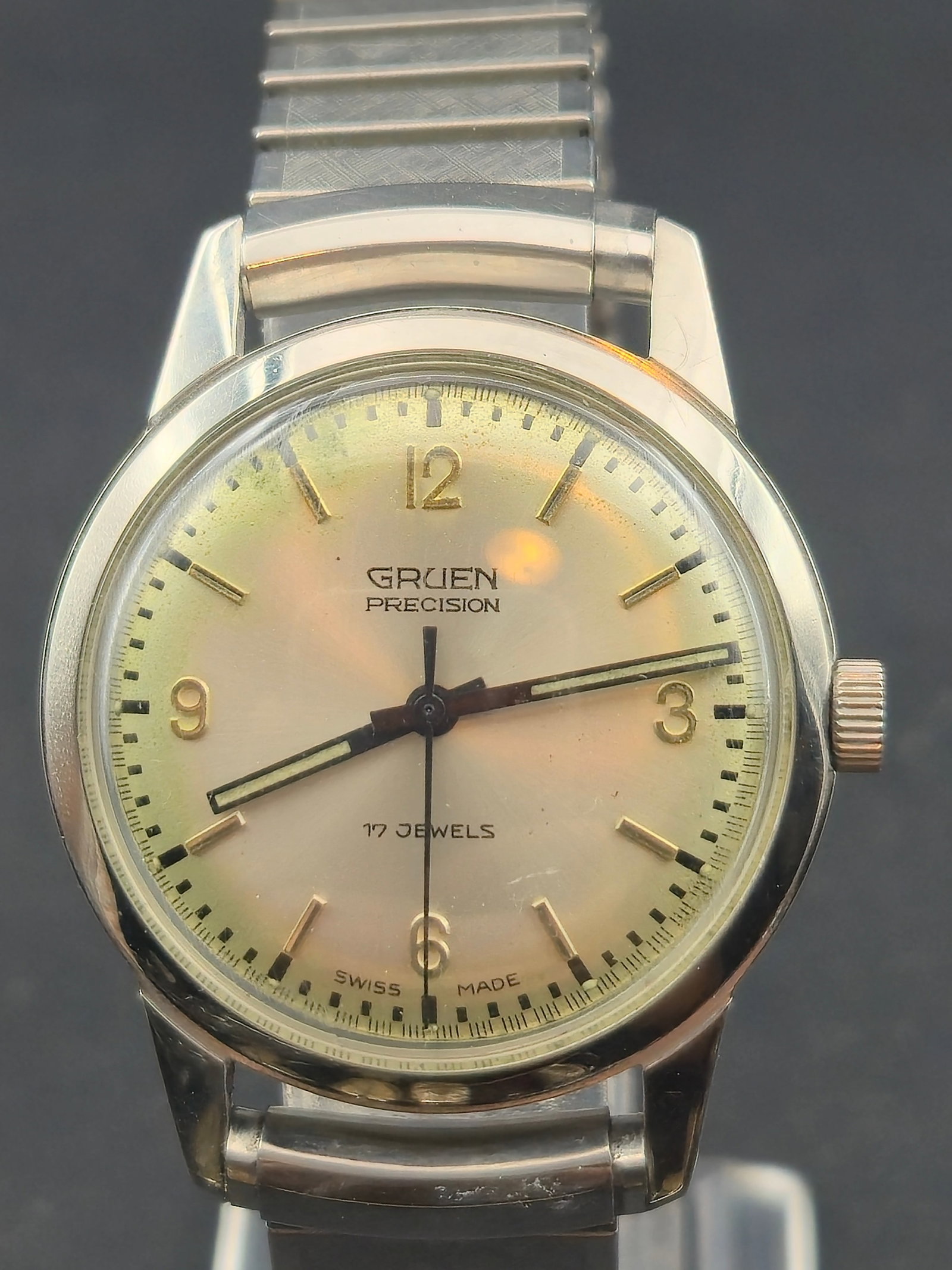 Gruen Precision 34mm Stainless Steel 17 Jewel Swiss Mens Watch Running: Gruen Precision wristwatch with stainless steel case and light toned dial marked Swiss Made. The movement is marked Gruen Watch Co and seventeen jewels. The watch is running. Wear to the case, dial, b