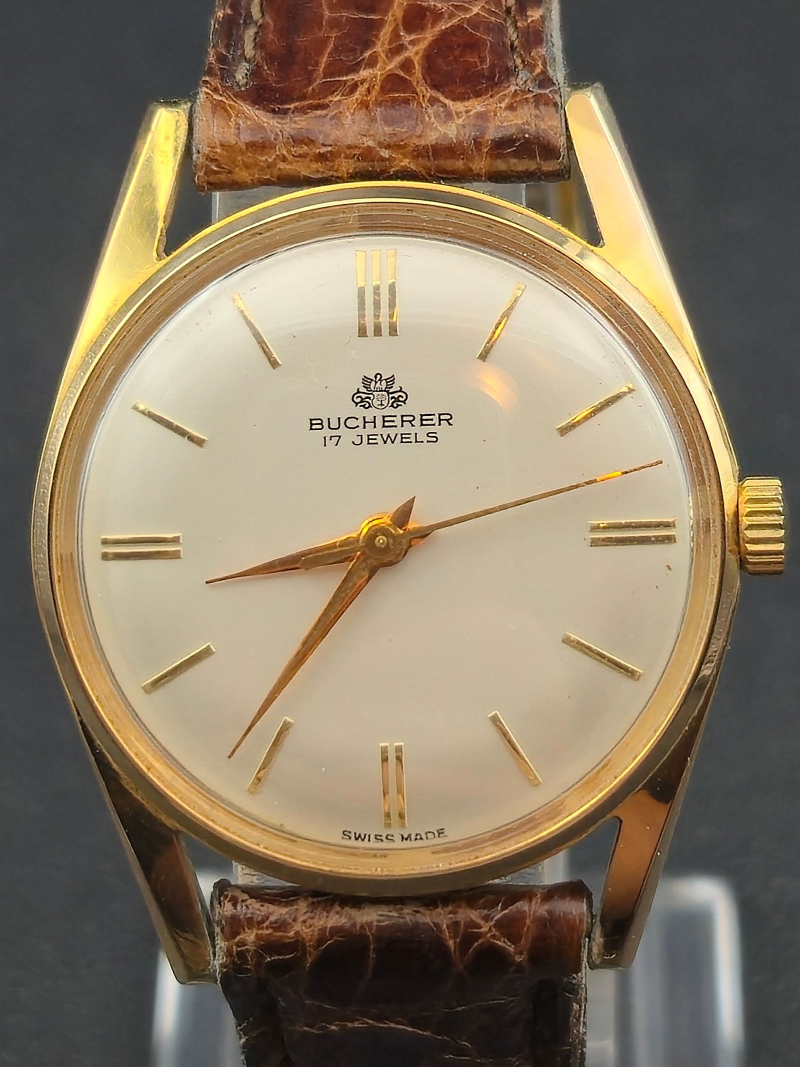 c.1965 Bucherer 32mm 17J Swiss Manual Dress Watch Runs Gold Tone Incabloc Mint: Vintage c.1965 Bucherer Swiss dress watch in mint condition, featuring a 32mm gold-tone case with stainless steel back and a clean minimalist dial with gold markers. Powered by a 17-jewel Bucherer Swi