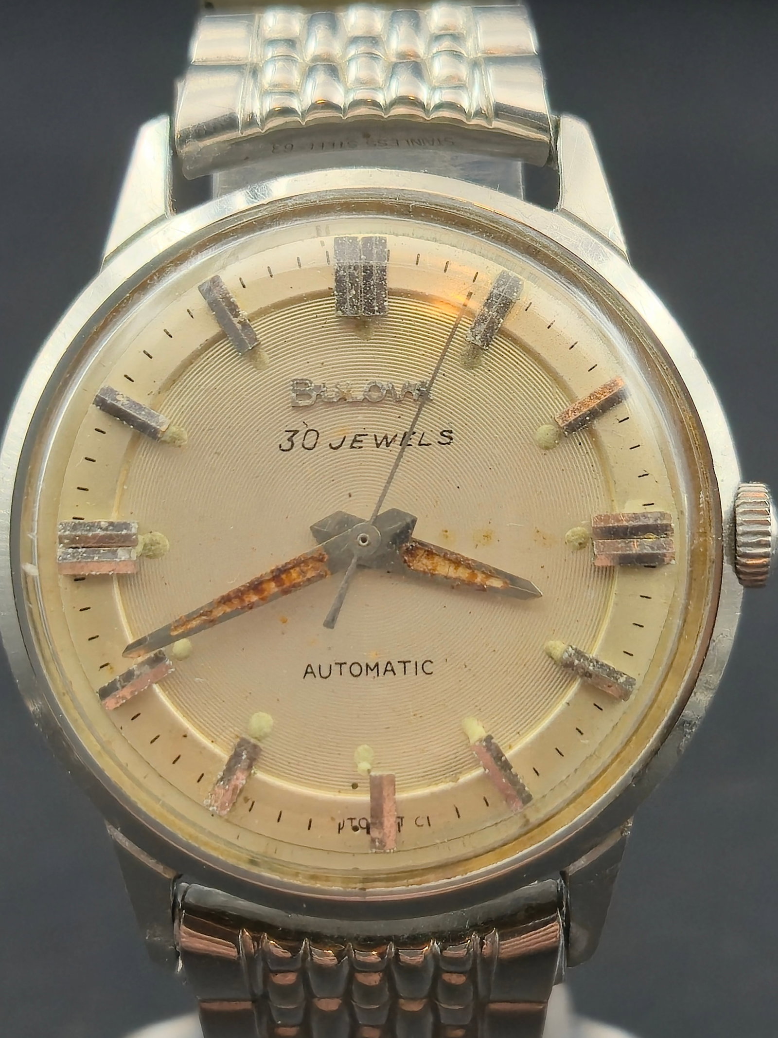 1960 Bulova 30 Jewel Automatic 33mm Stainless Steel Dress Watch Runs: Classic early-1960s Bulova 30 Jewel automatic wristwatch featuring a stainless steel case, original champagne dial, and raised metallic indices. Powered by the high-grade Bulova 10COAC 30 jewel automa