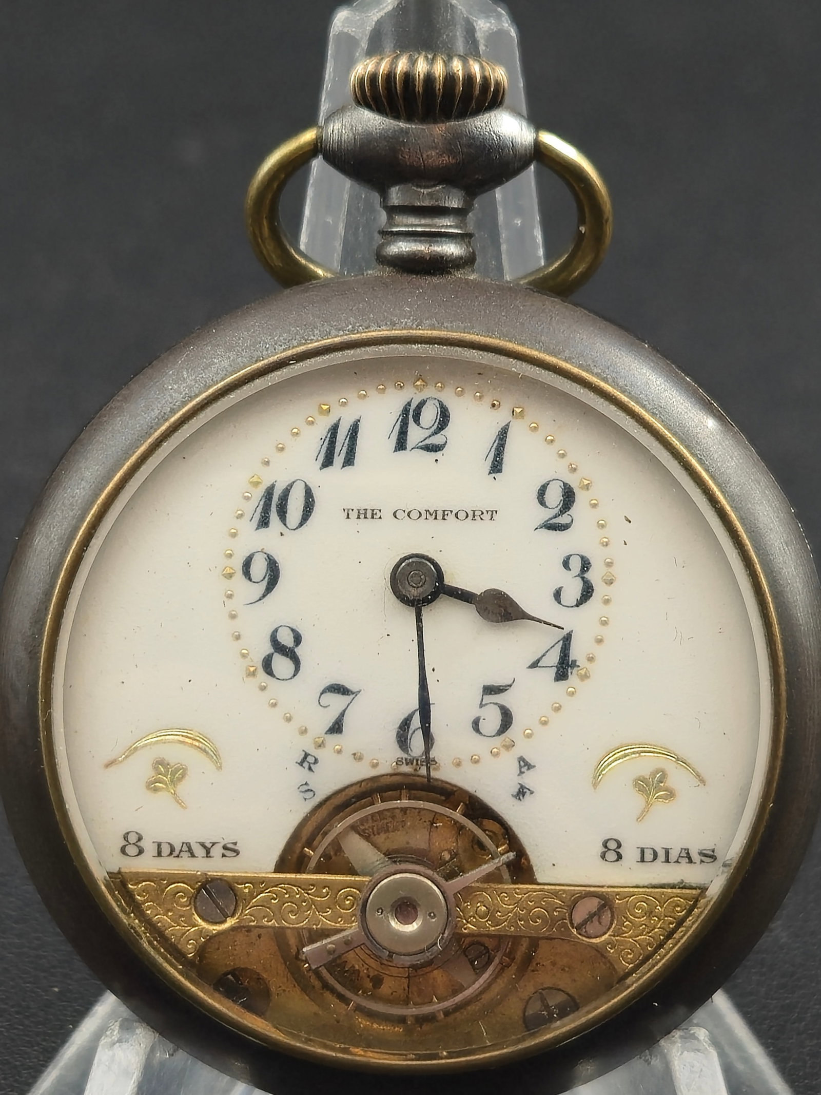 c.1920s Swiss “The Comfort” 8-Day 50mm Visible Balance Pocket Watch – Runs: A circa 1920s Swiss-made “The Comfort” pocket watch featuring an uncommon 8-Day movement with visible balance cutout at the bottom of the dial. The piece displays ornate gold-tone dial decorat