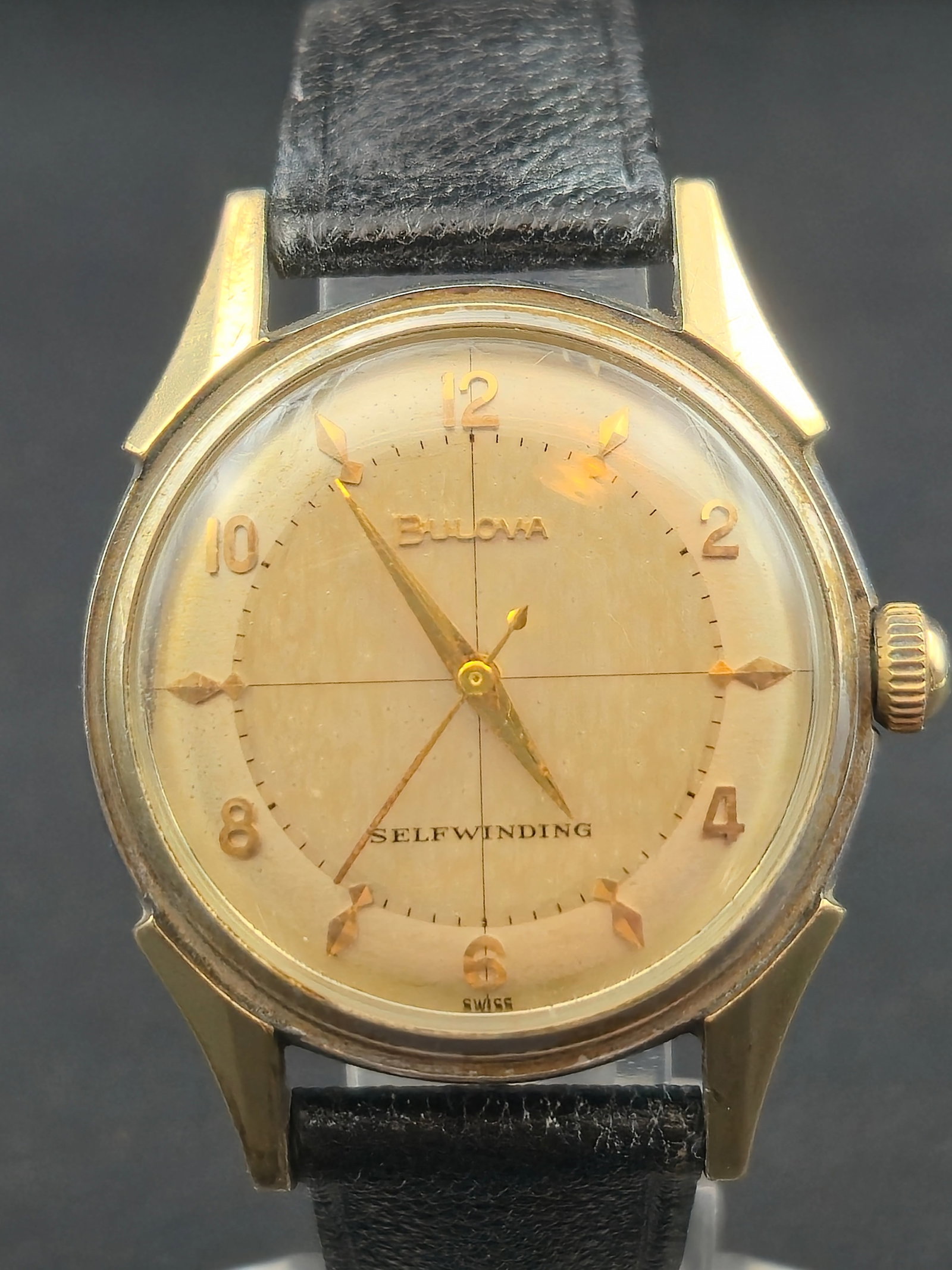 Bulova Selfwinding Automatic 17J Wristwatch c.1950s 33.7mm Gold-Tone Runs: Vintage Bulova Swiss selfwinding automatic wristwatch featuring a warm champagne dial with applied gold Arabic numerals and faceted markers, crosshair layout, and matching gold hands. Dial signed “B