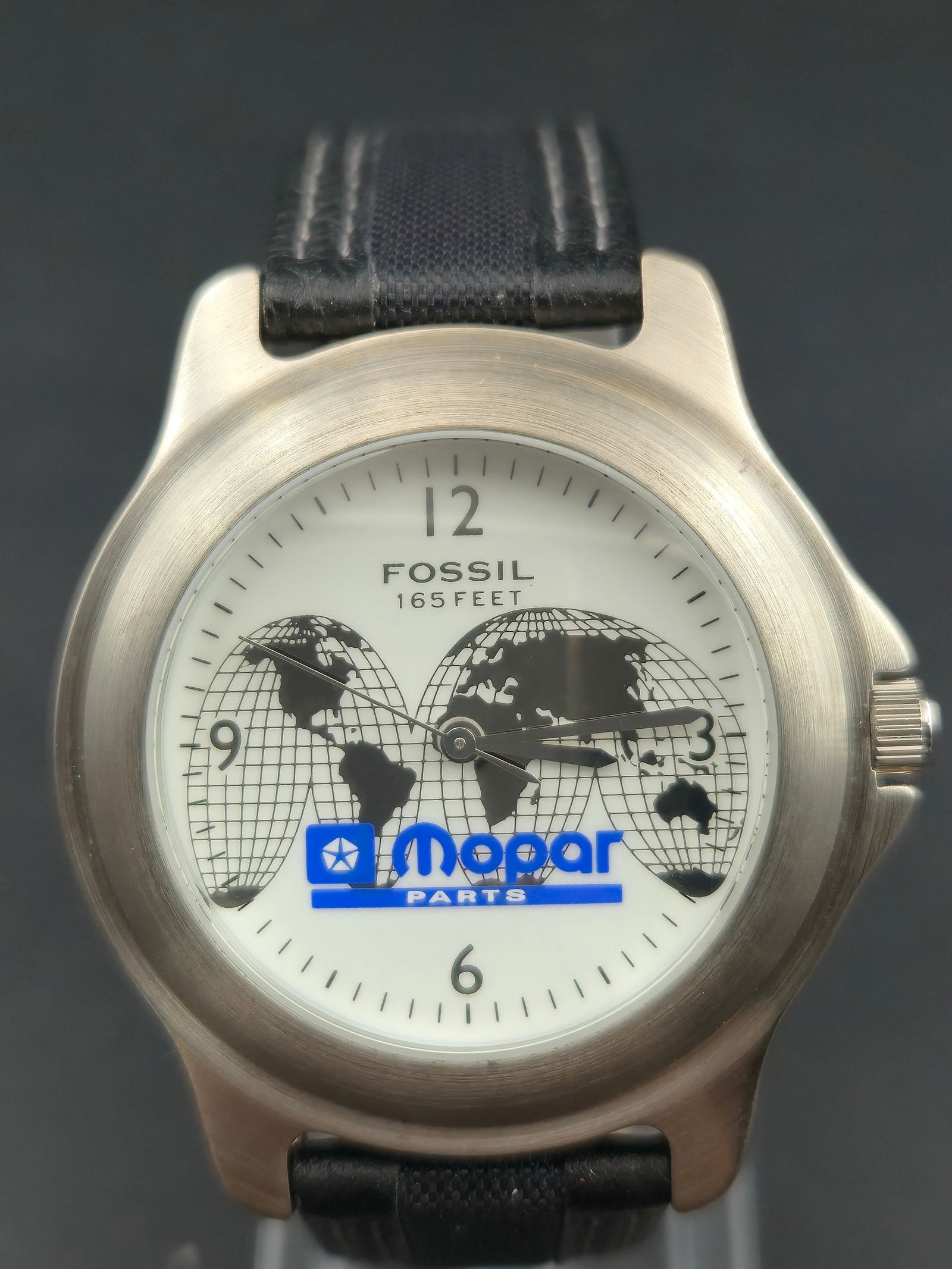 Fossil Mopar Master Parts Limited Edition Watch 30.69mm Stainless Steel Box Papers New Battery: Fossil Master Parts – Mopar limited edition wristwatch made exclusively by Fossil for Mopar. White dial with world map graphic, bold Arabic numerals at 12, 3, 6, and 9, and Mopar Parts logo at cente