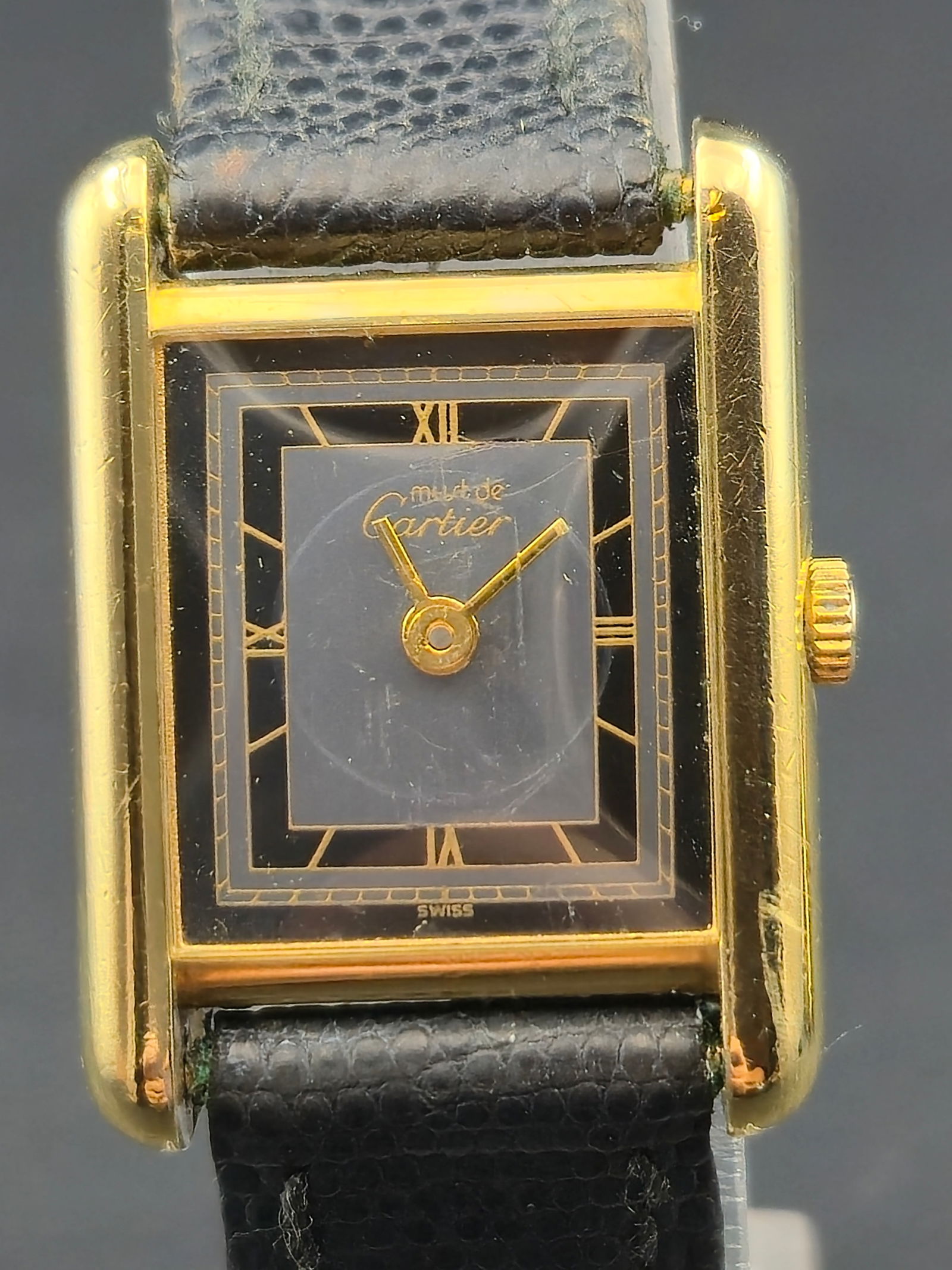 Cartier Tank Vermeil Argent 925 Quartz Black Roman Dial circa 1990: Cartier Tank Vermeil quartz wristwatch, running and keeping time at the time of listing. Rectangular Tank-style case marked Vermeil and Argent 925 with gold plating and Swiss made. The watch features
