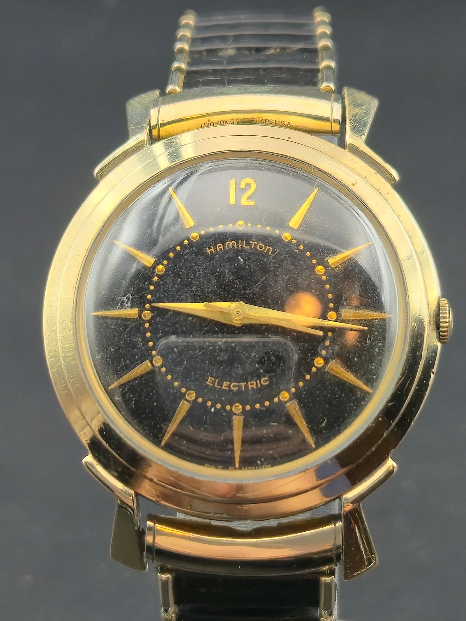 Hamilton Electric Black Dial Wristwatch 10K Gold-Filled c.1957: Early Hamilton Electric wristwatch featuring the desirable black dial with applied gold hour markers and matching gold hands. This watch houses the pioneering Hamilton Electric caliber 500 battery-pow