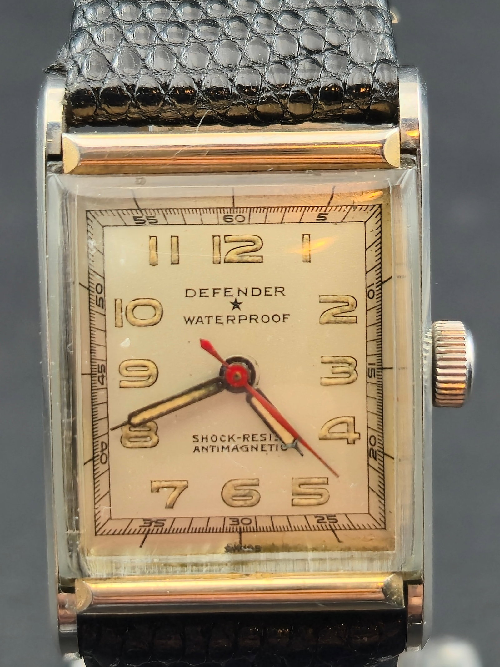 Defender Waterproof Rectangular Wristwatch Stainless Steel c.1940 Runs: Vintage Defender rectangular wristwatch featuring a classic Art Deco–era design with bold applied Arabic numerals and subsidiary minute track. Dial is marked Defender Waterproof with additional shoc
